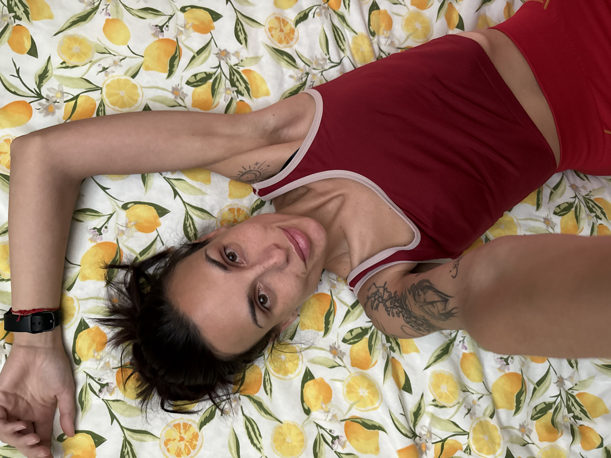 Person photographed on lemon-patterned bed in Pleven, Bulgaria