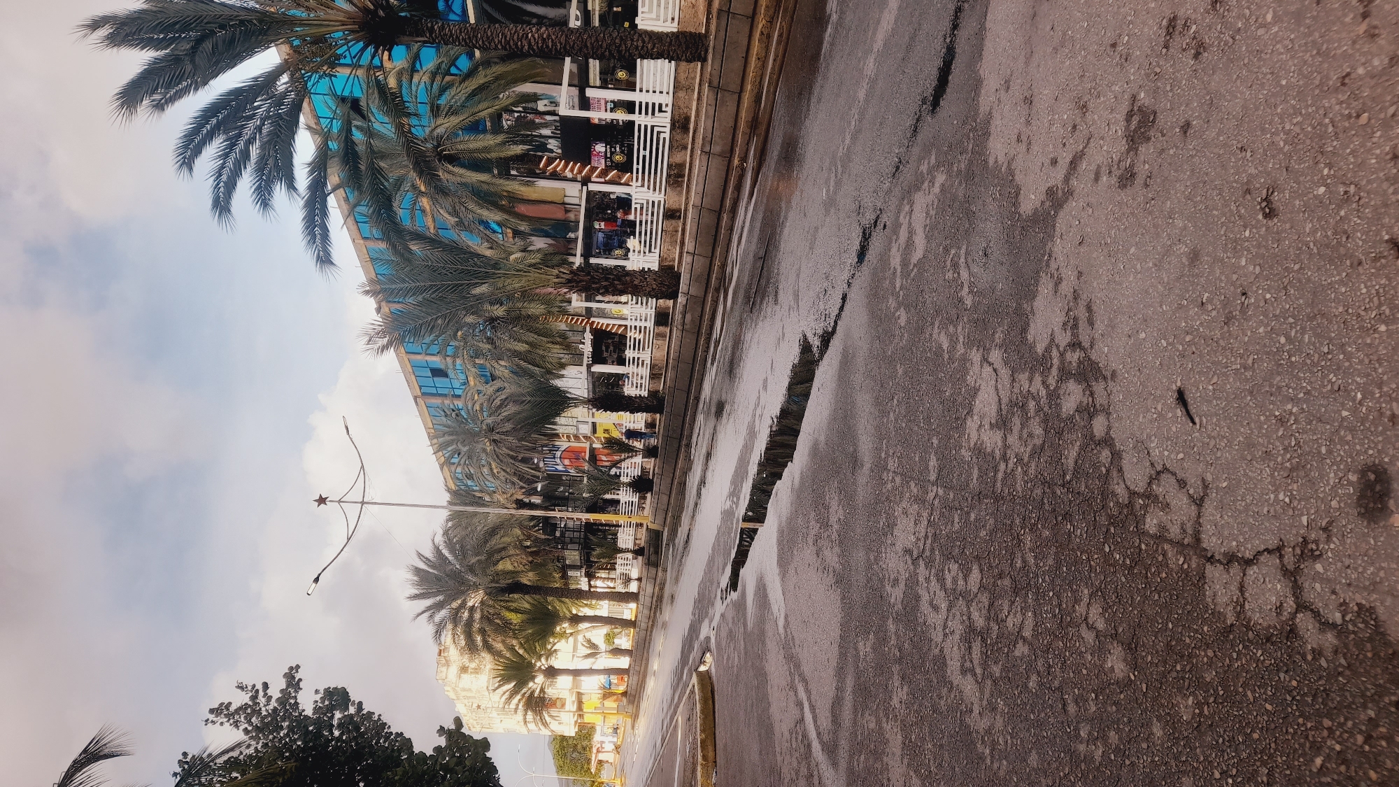 Cracked, flooded street in Juan Griego after rain