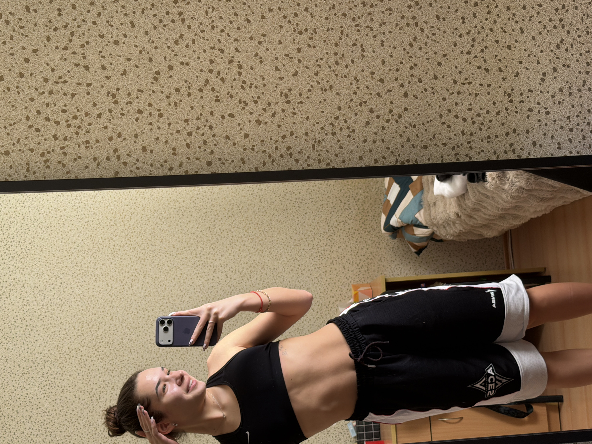 Woman takes mirror selfies in athletic wear, Sofia