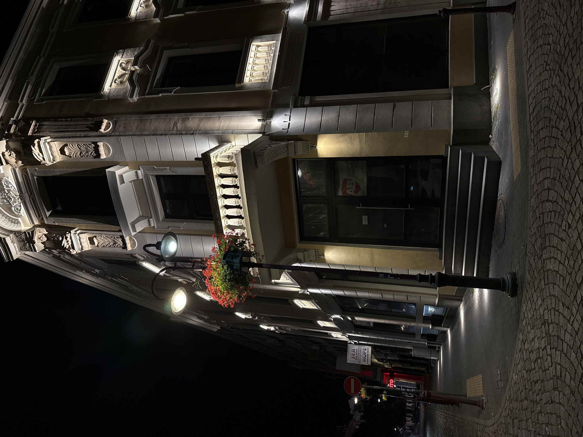 Ornate illuminated building at a Burgas street corner at night