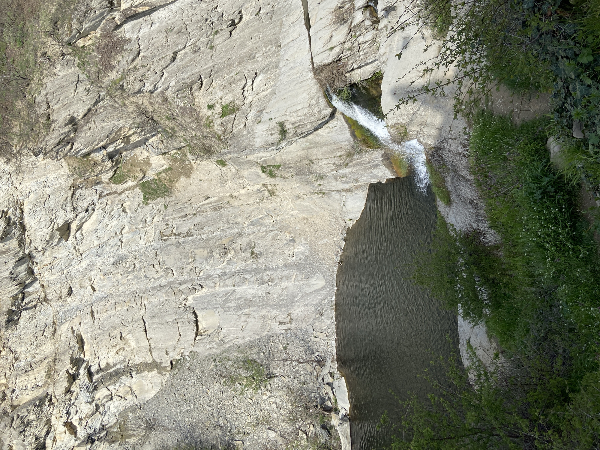 Cyclist documents waterfalls and stretching near Bulgarian monastery