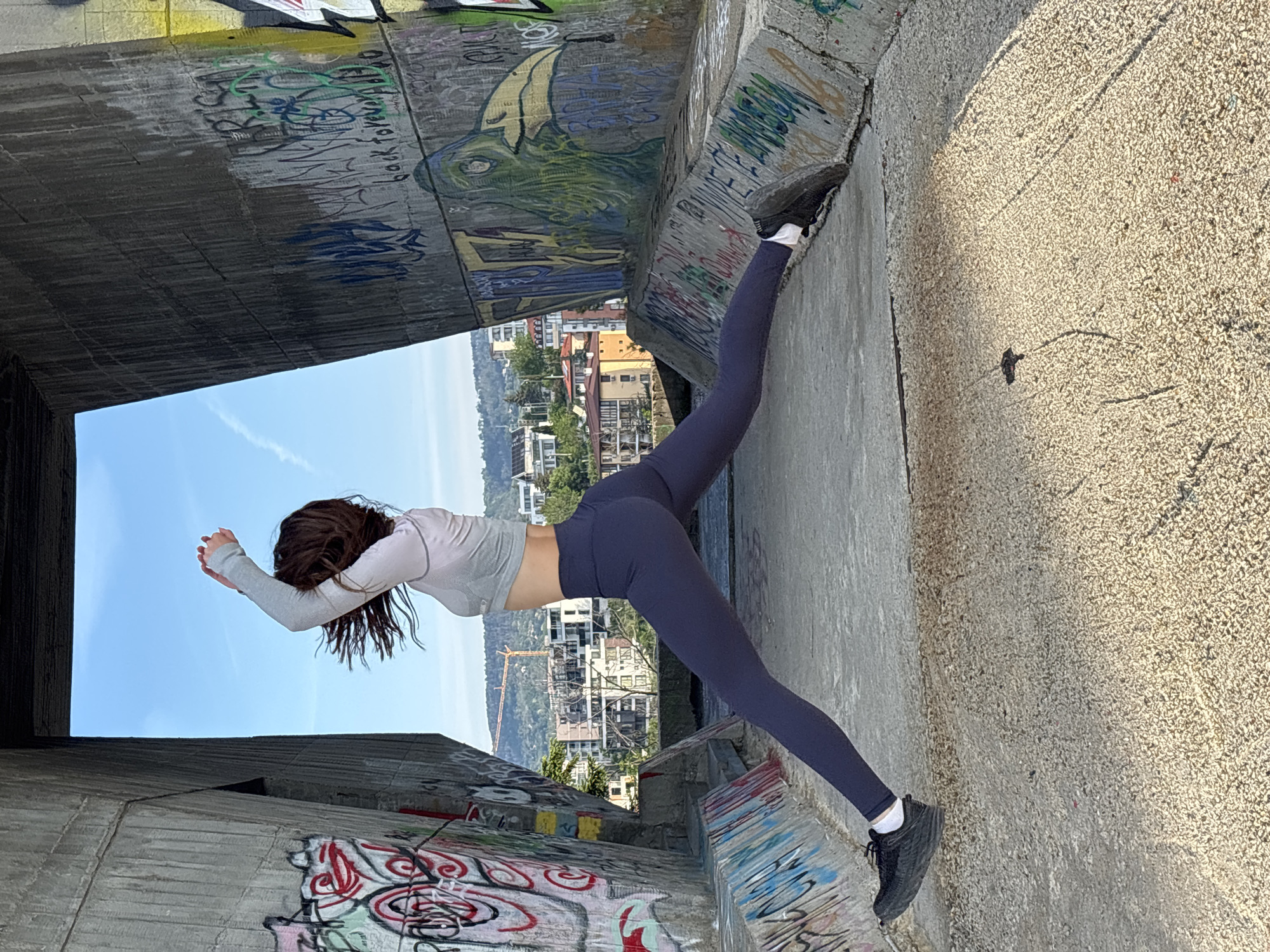 Early morning yoga session at graffitied Soviet monument in Varna