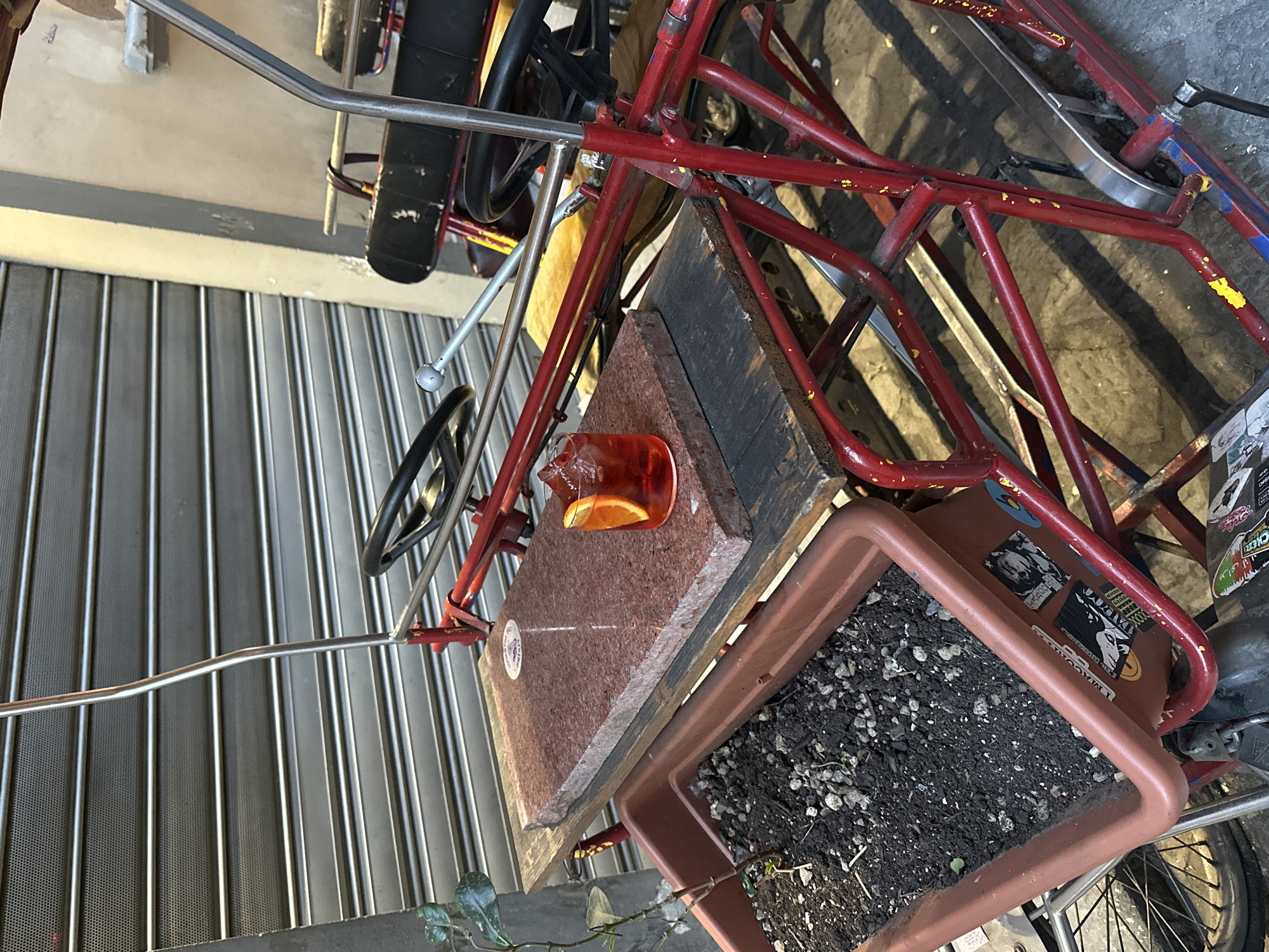 Red vendor cart spotted near shuttered storefront in Florence