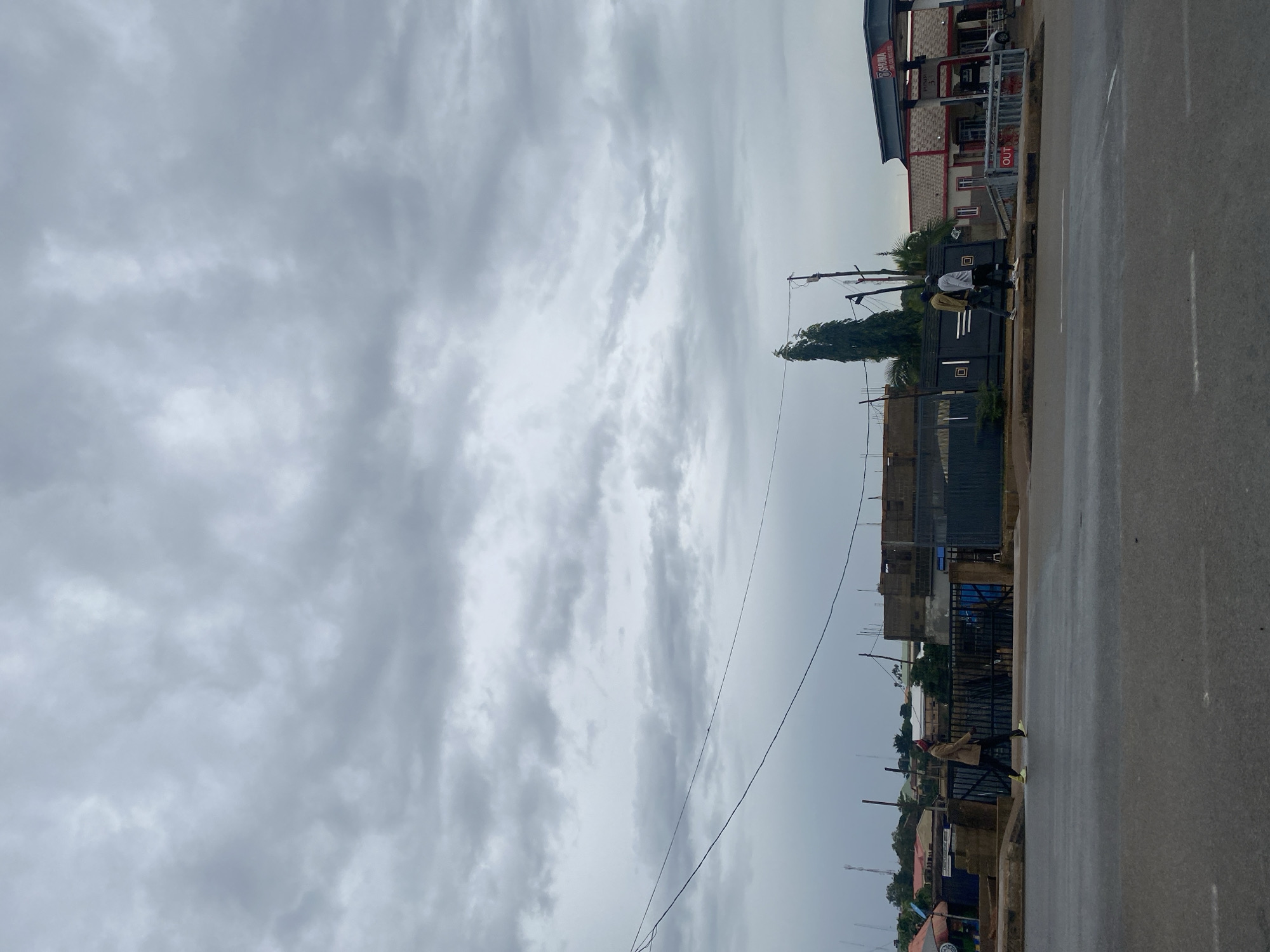 Wet streets and light traffic on a cloudy Jos morning