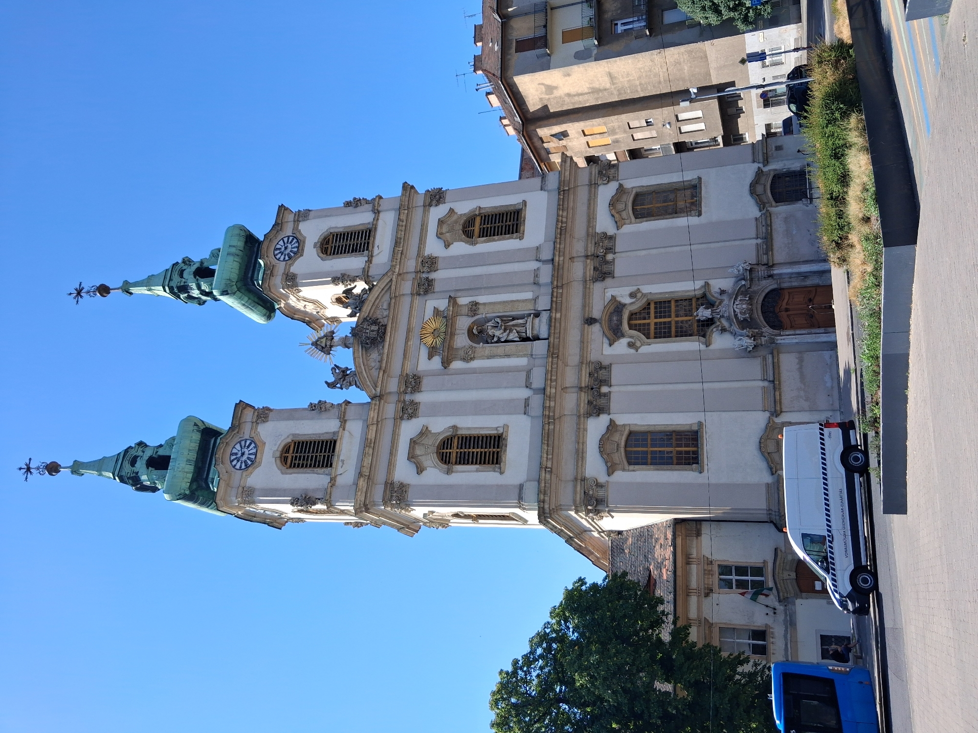 Baroque church and a resting dog on a sunny Budapest morning
