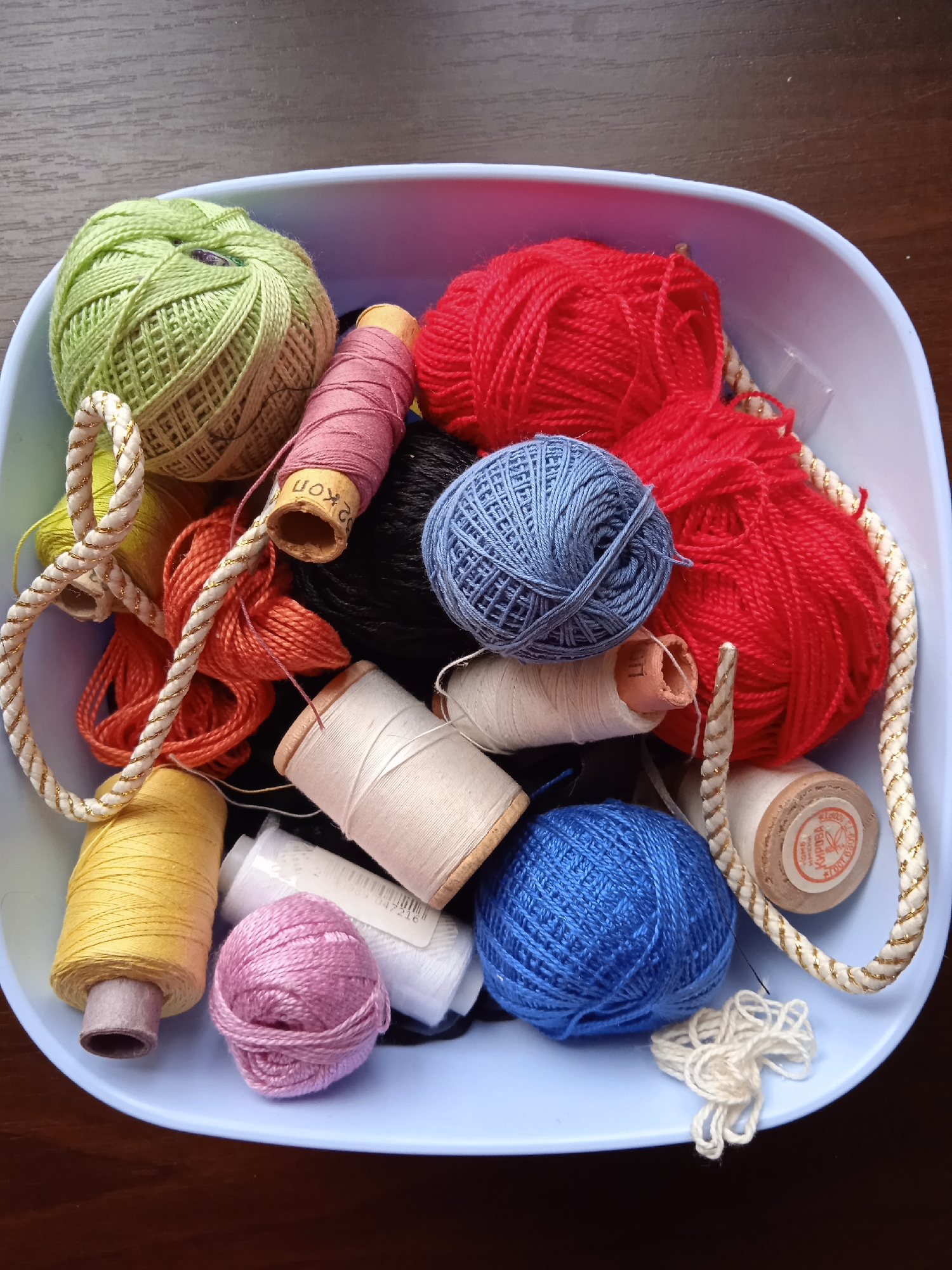 Handcraft supplies and small decorative objects on wooden surfaces