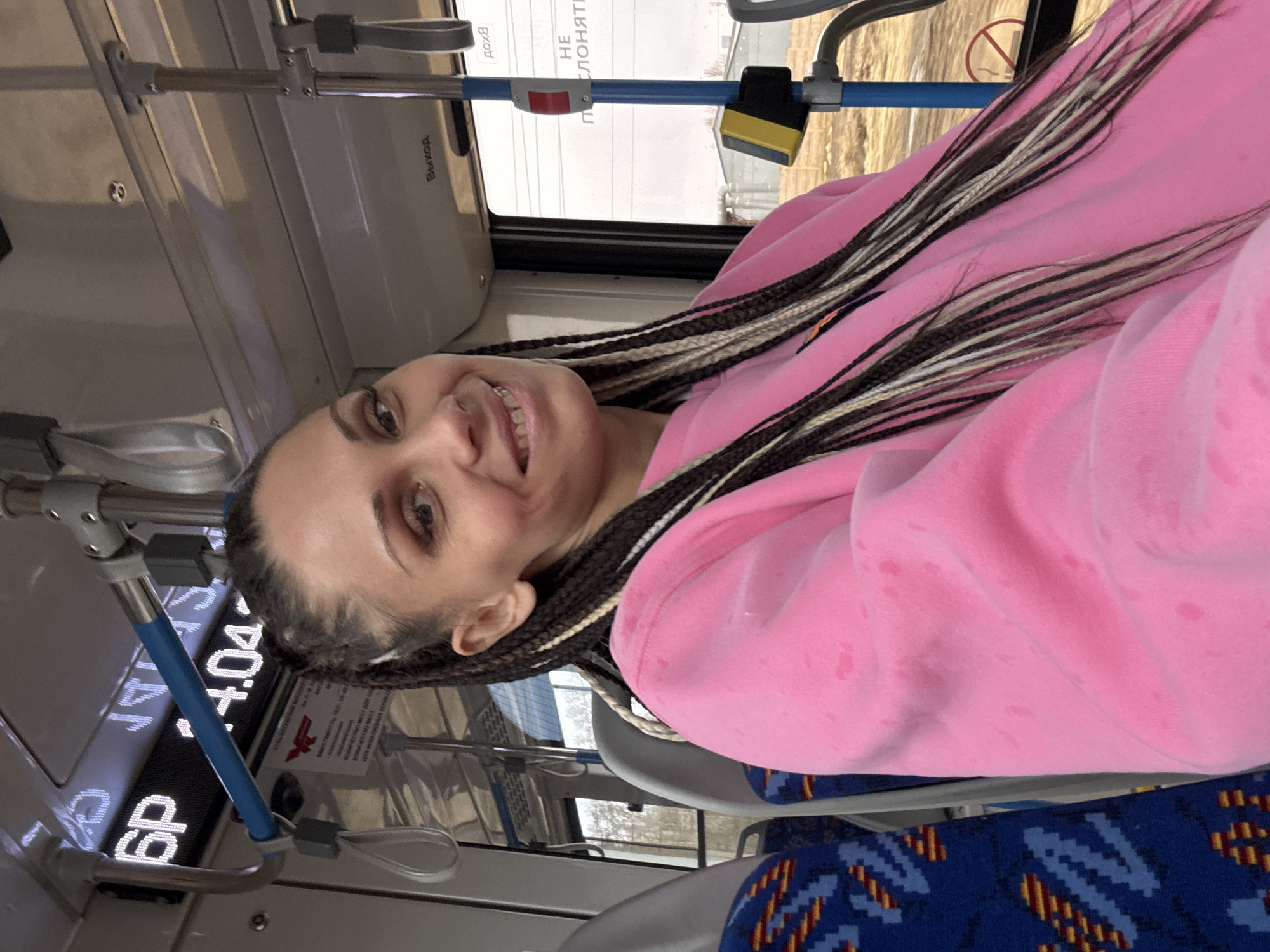Woman documents public transit journey in pink sweater