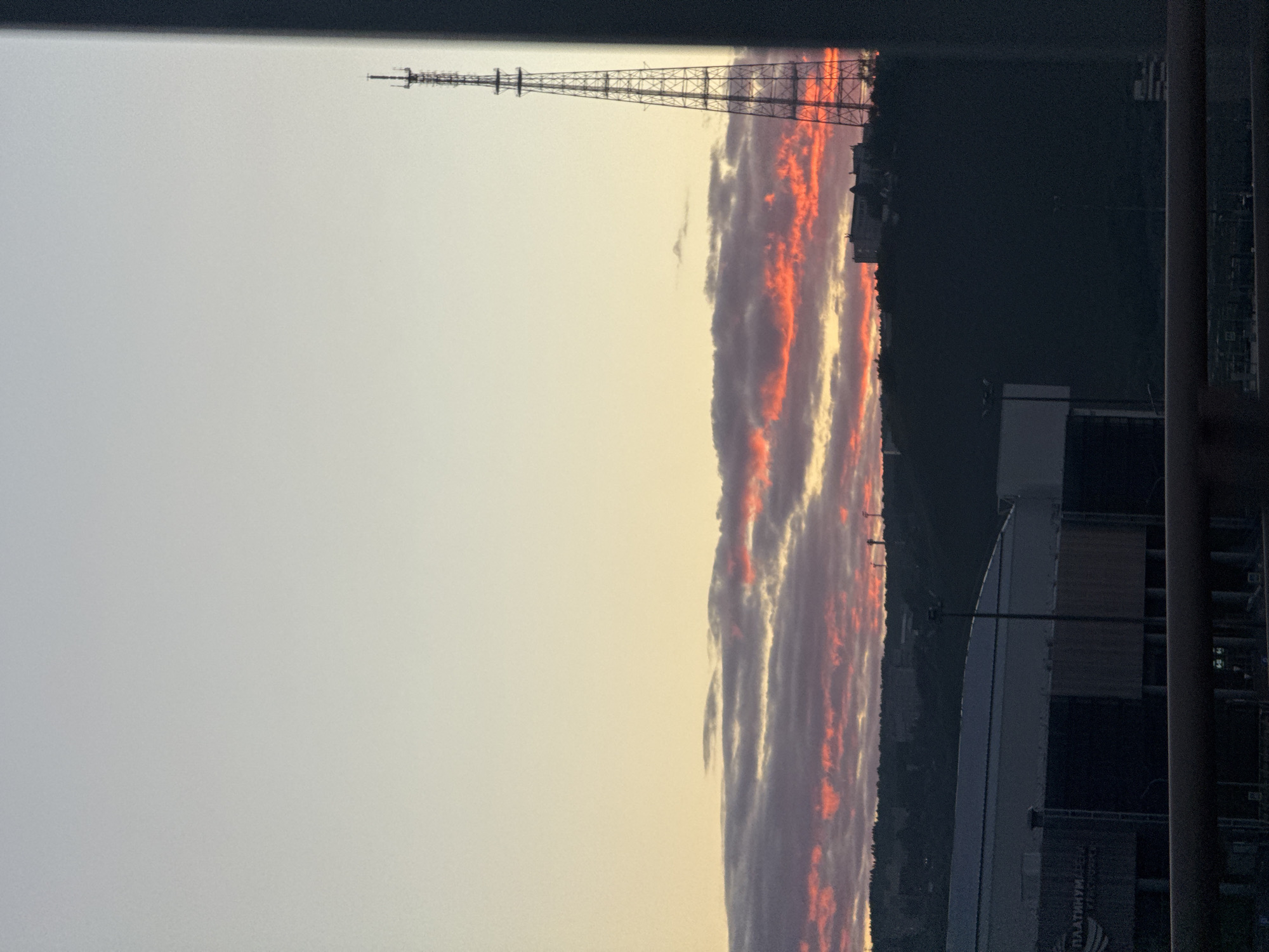 Sunset over Krasnoyarsk: river, mountains, and city skyline at dusk