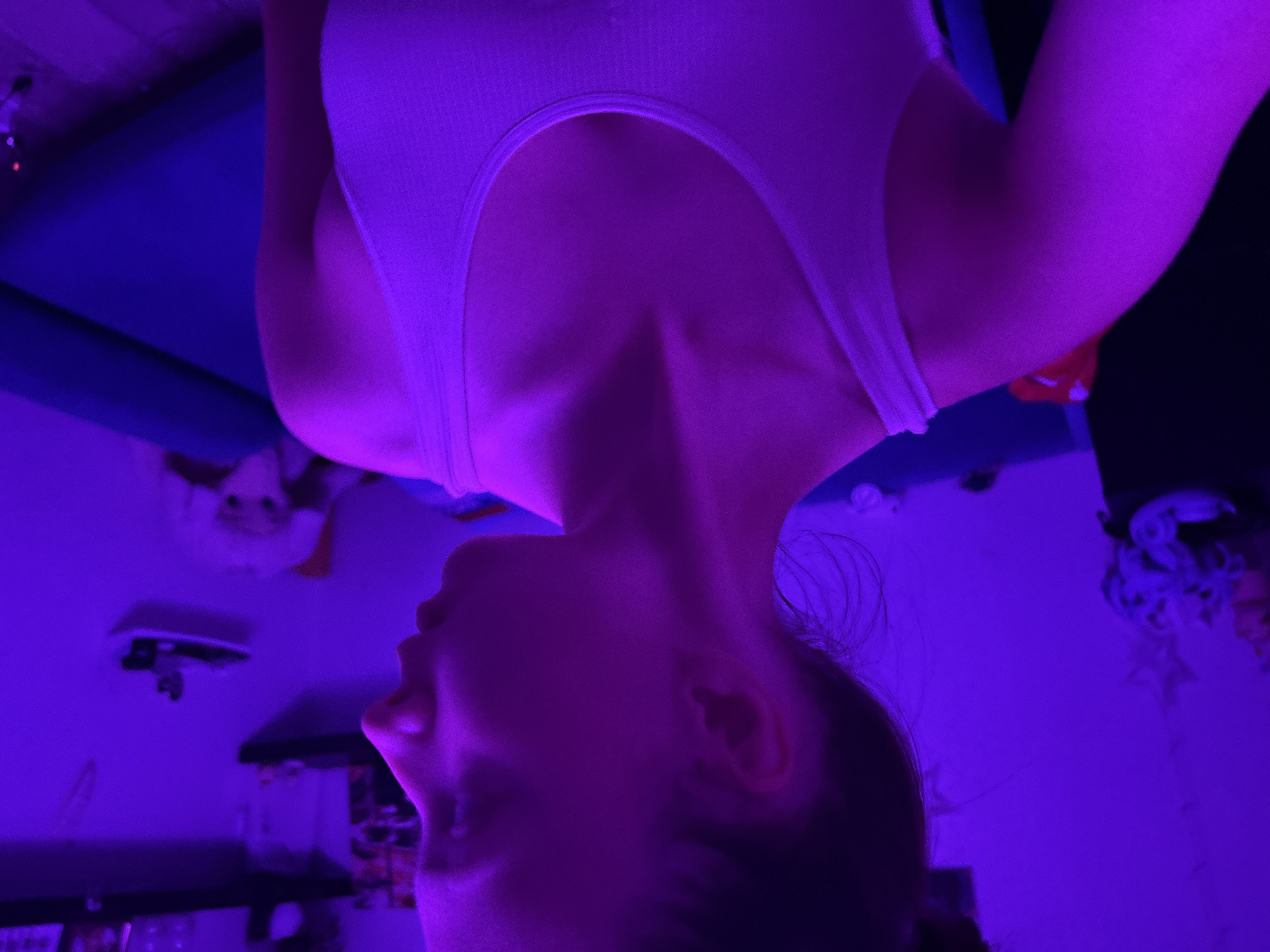 Woman observed in purple-lit room in Прикамский, Russia