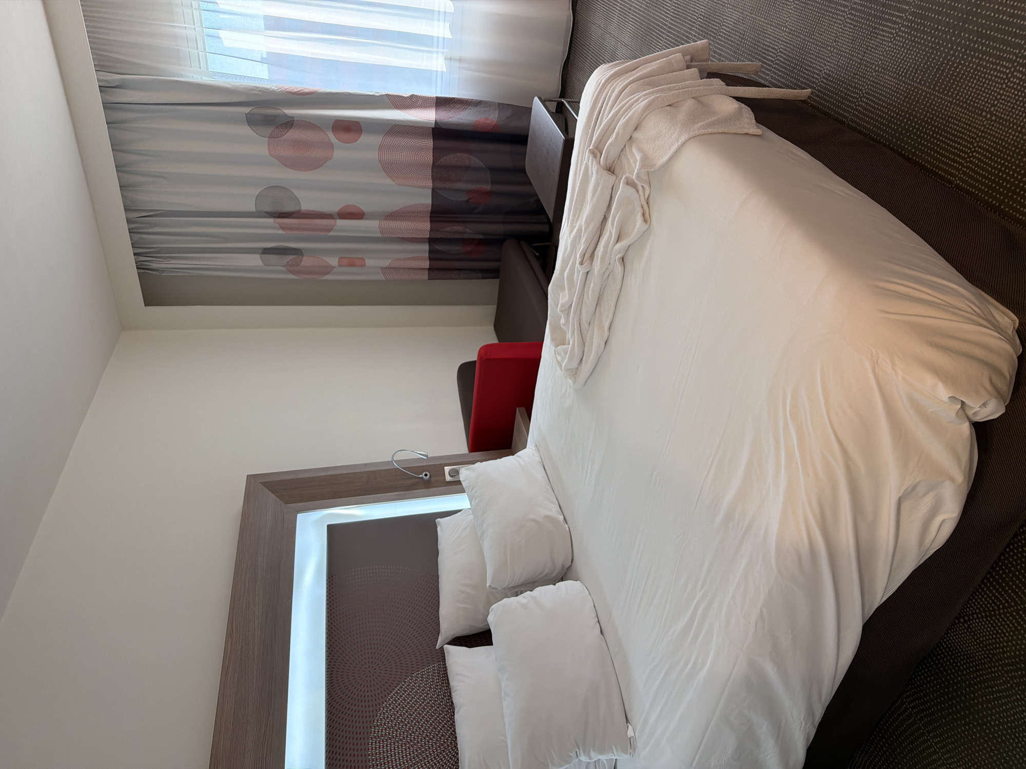 Inside a Khimki hotel room with luggage and atrium views