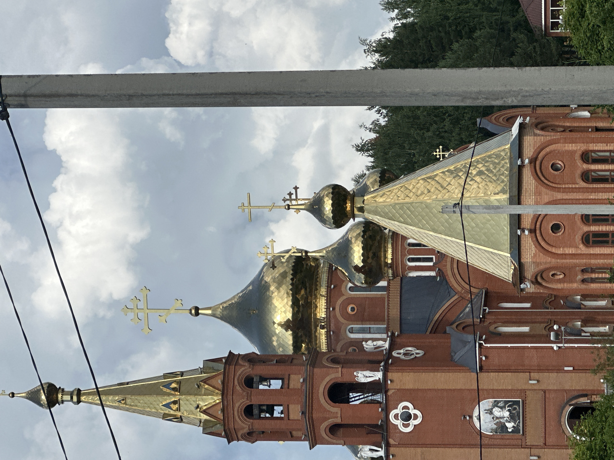 Double rainbow over Russian Orthodox church and forests