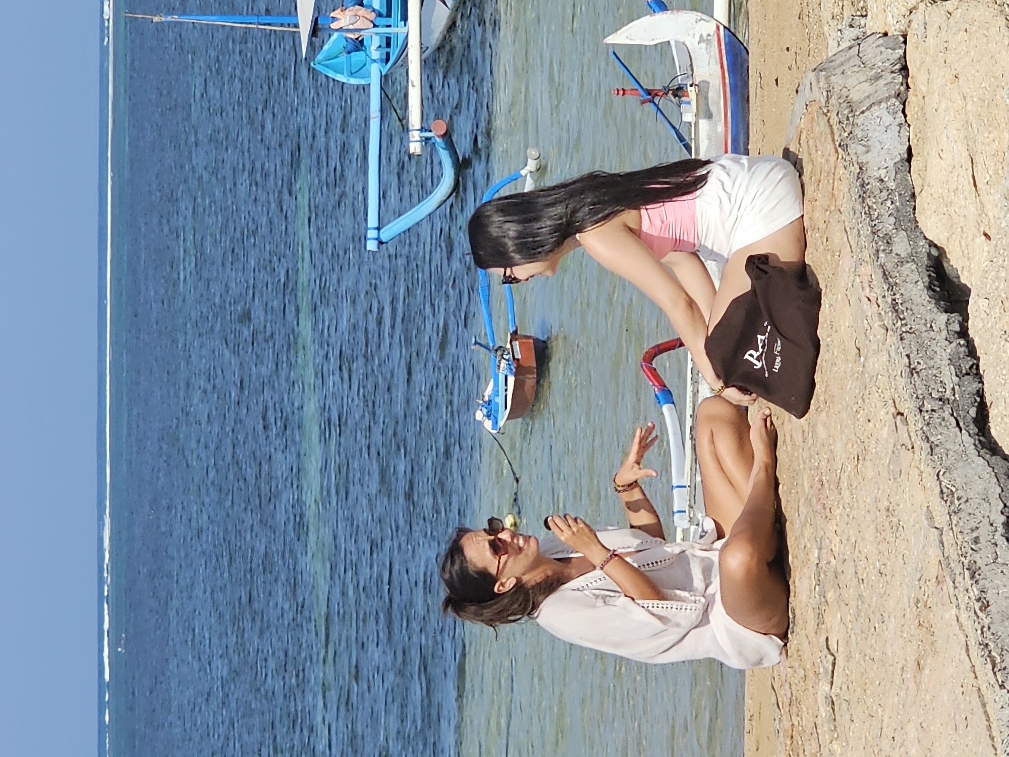 Beach morning in Denpasar: swimming, shoreline, and sand