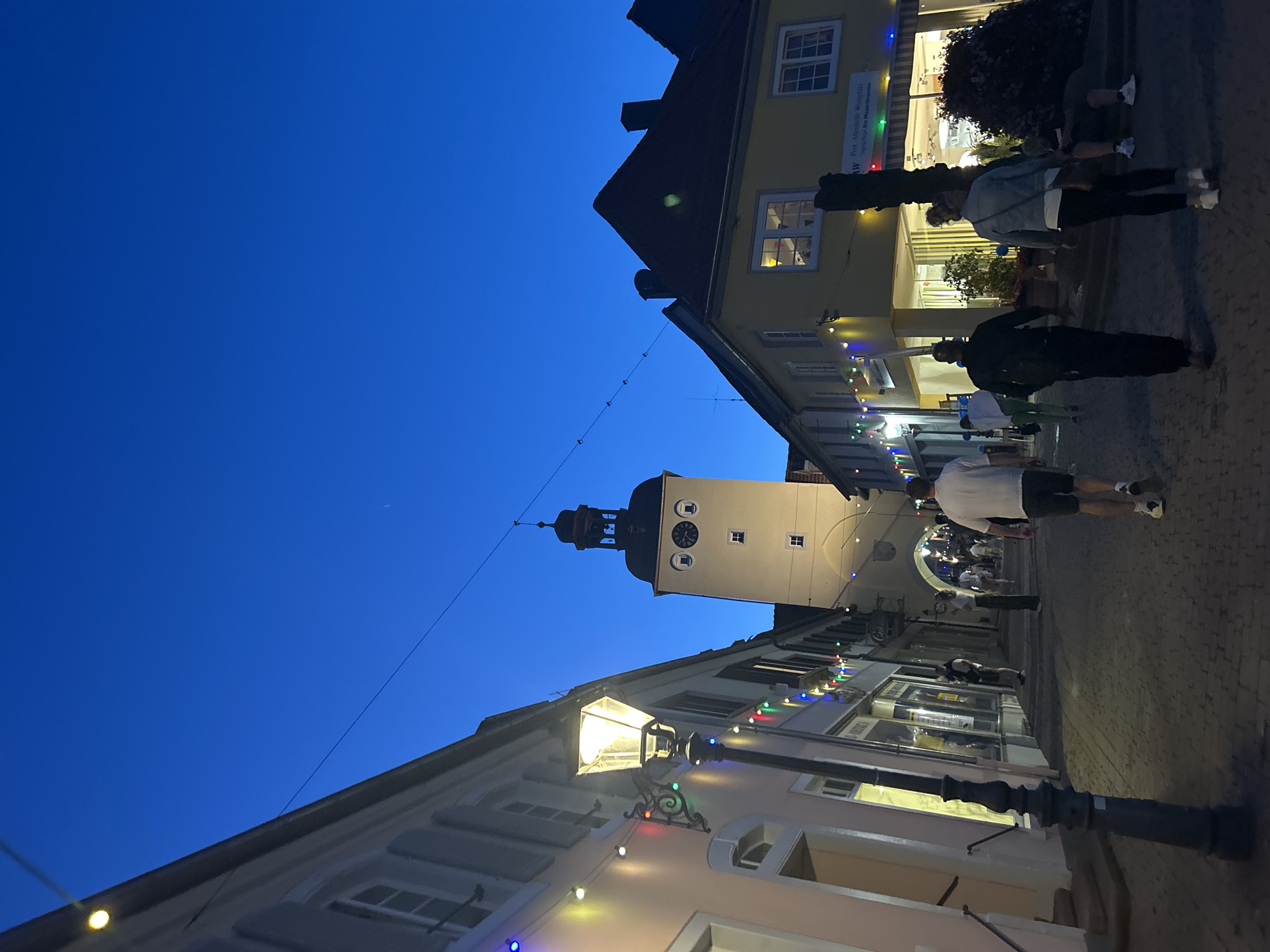 Twilight stroll through a lit-up German town square