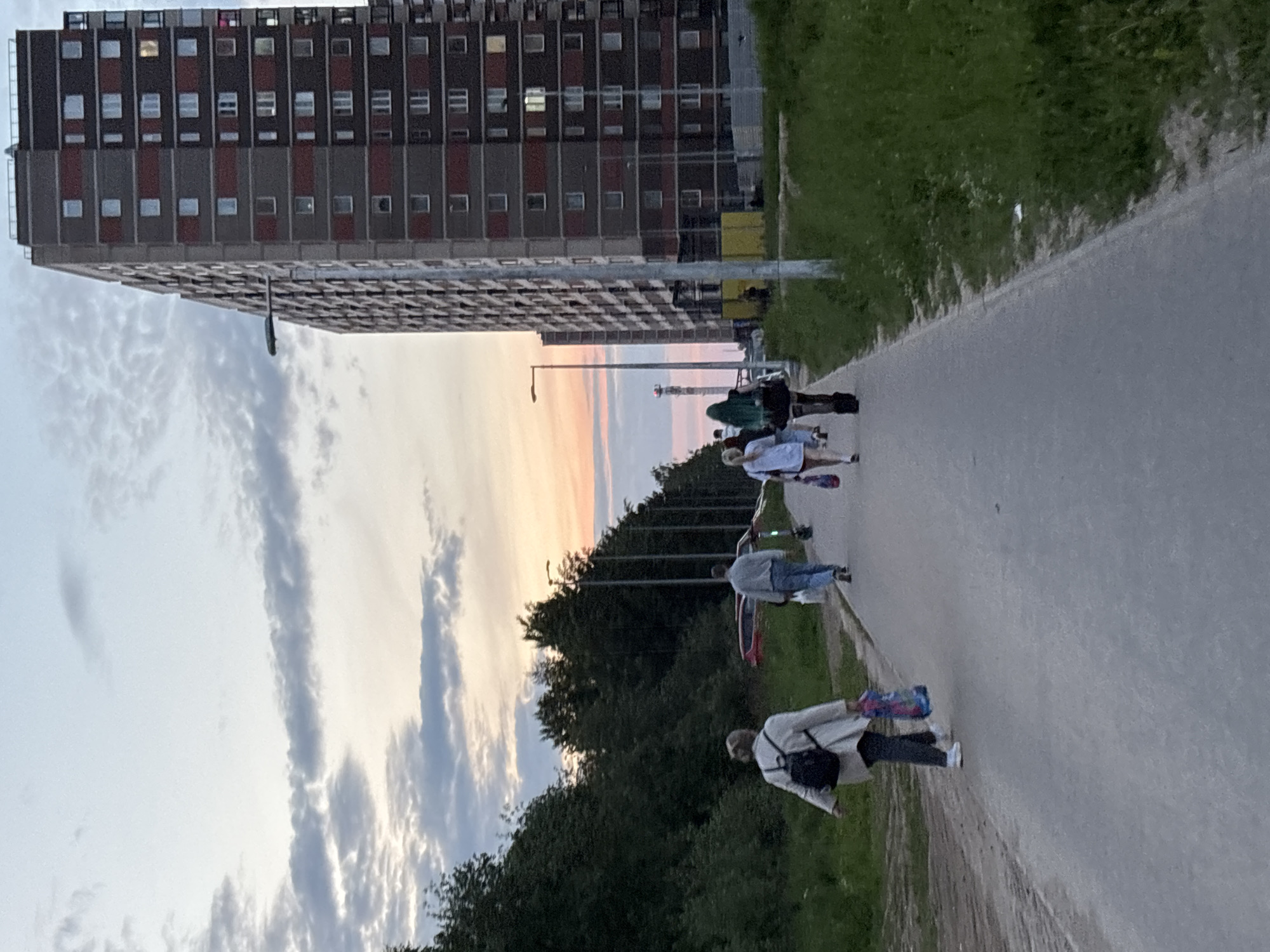 Young skateboarders gather at dusk in Sinyavino residential area