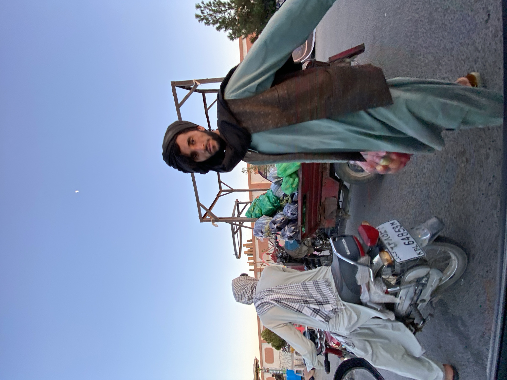 Street vendors and daily traffic moving through Kandahar's busy market district