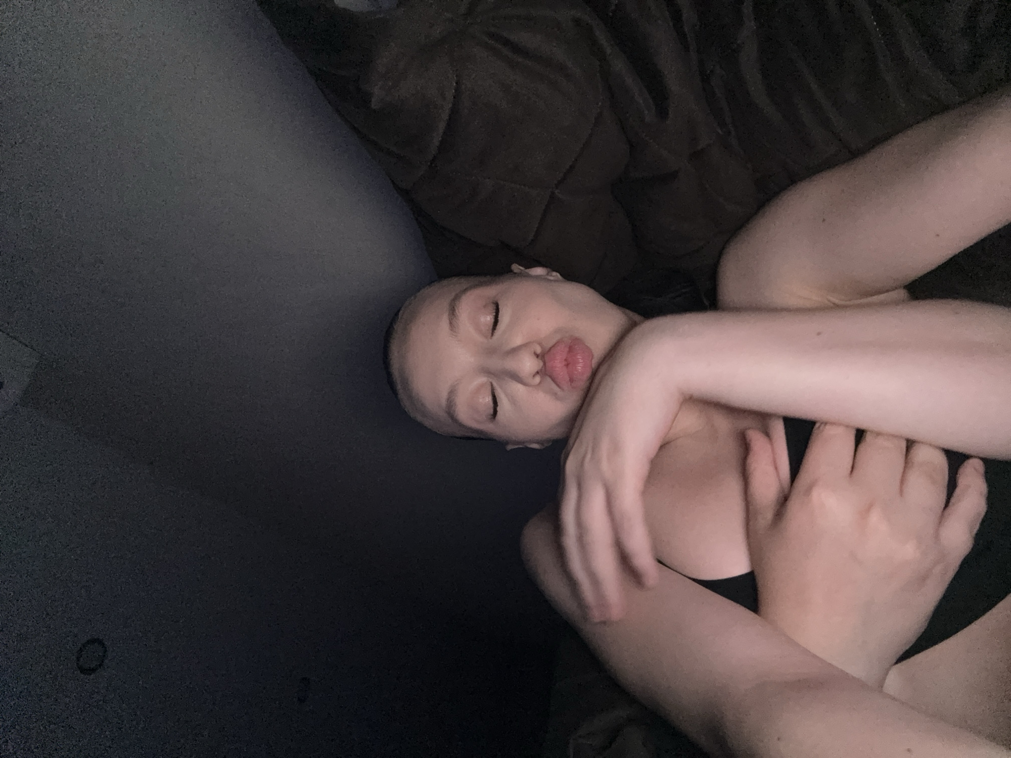 Close-up portrait, eyes closed, lips puckered for a kiss.