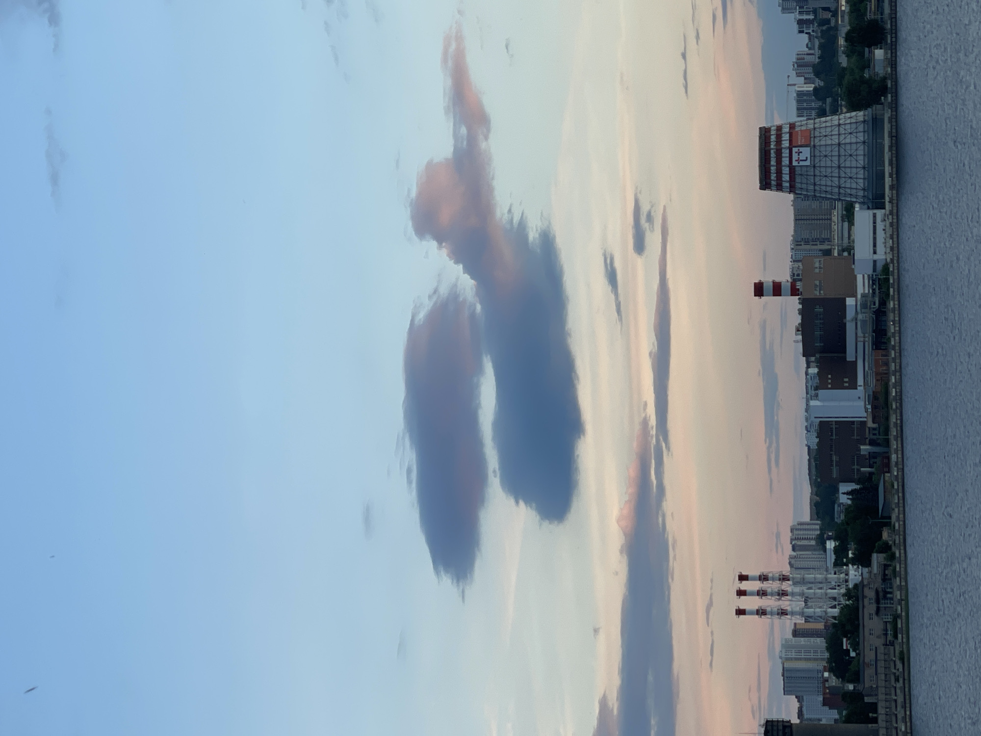 Evening life captured across urban waterfront during sunset hours