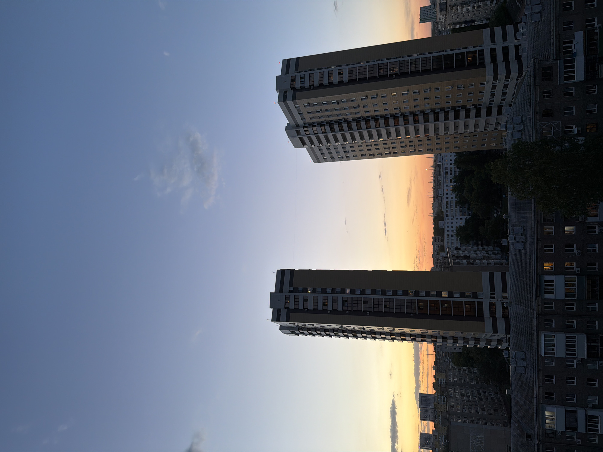 Urban dusk captured at residential towers with lit windows