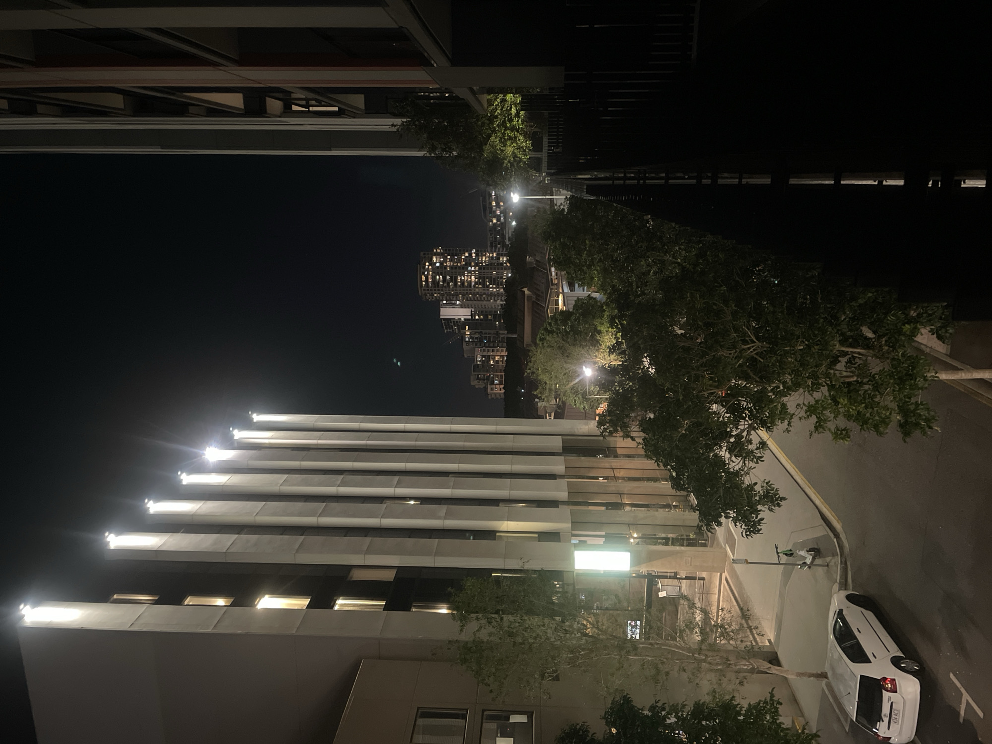 Brisbane night: city streets, a balcony, and cozy interiors