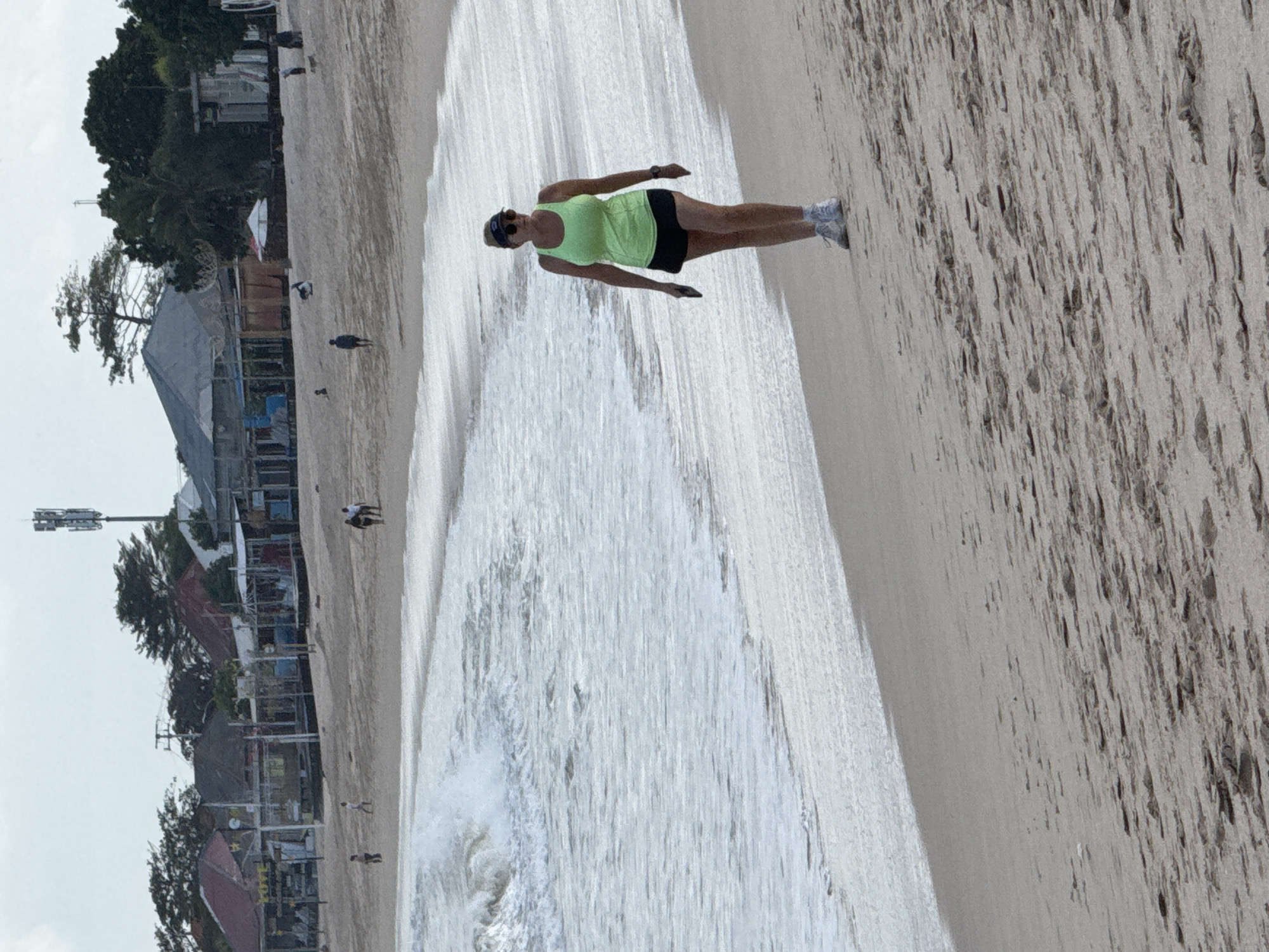 Kuta Beach shoreline with planes, boats, and breaking waves
