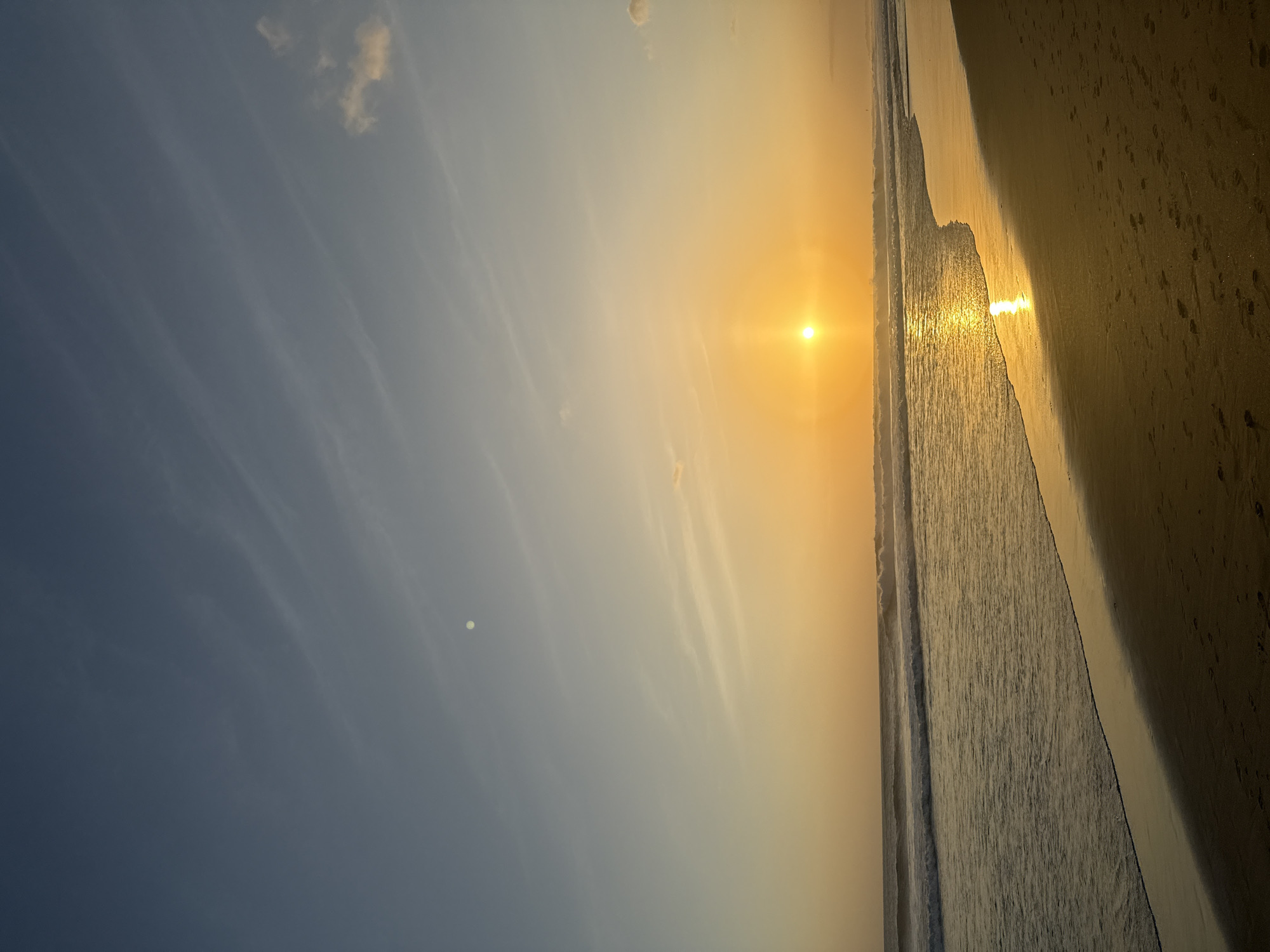 Sunset over North Kuta beach, soft gradients and wispy clouds