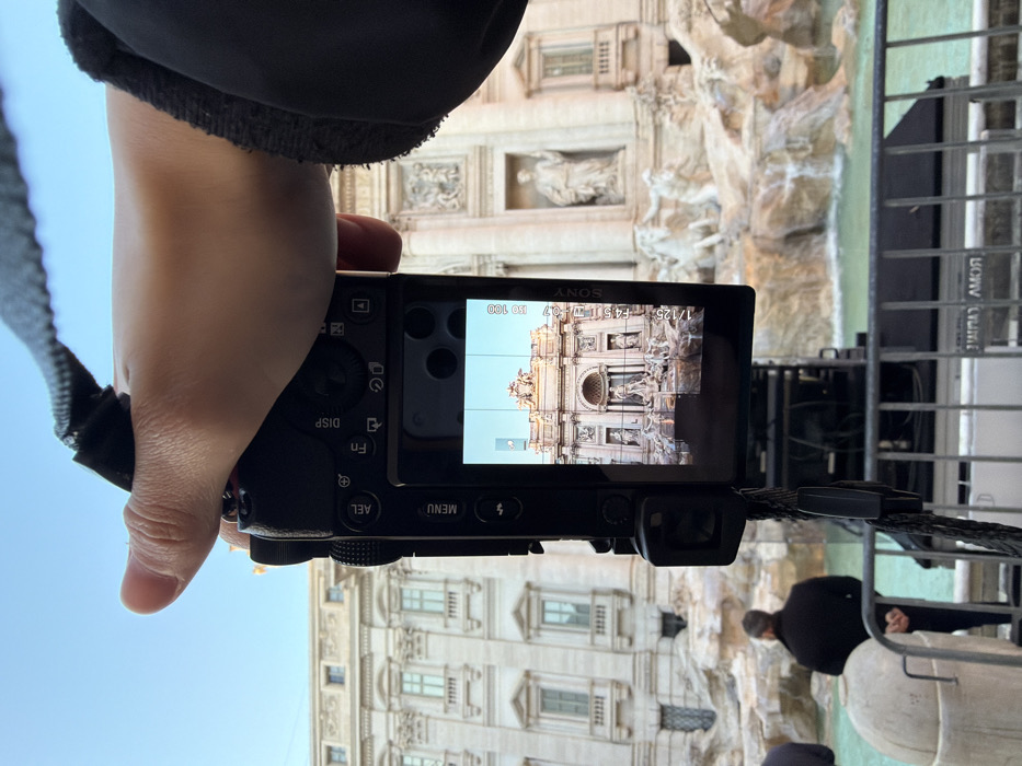 Tourist photographs Trevi Fountain with Sony camera in Rome