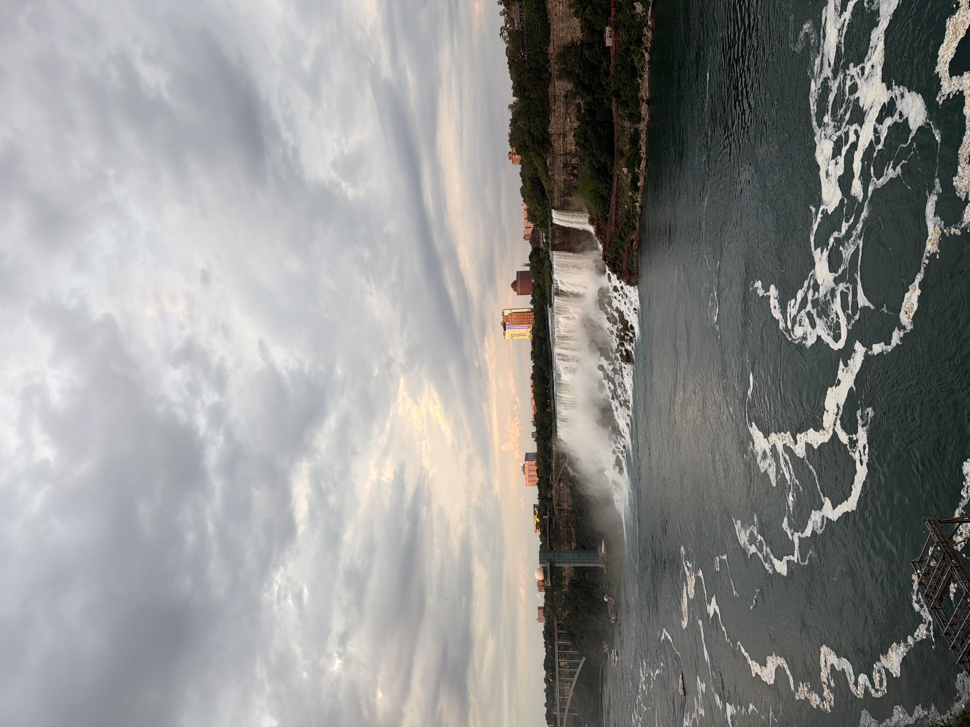 Horseshoe Falls at dusk, mist rising, buildings on the ridge