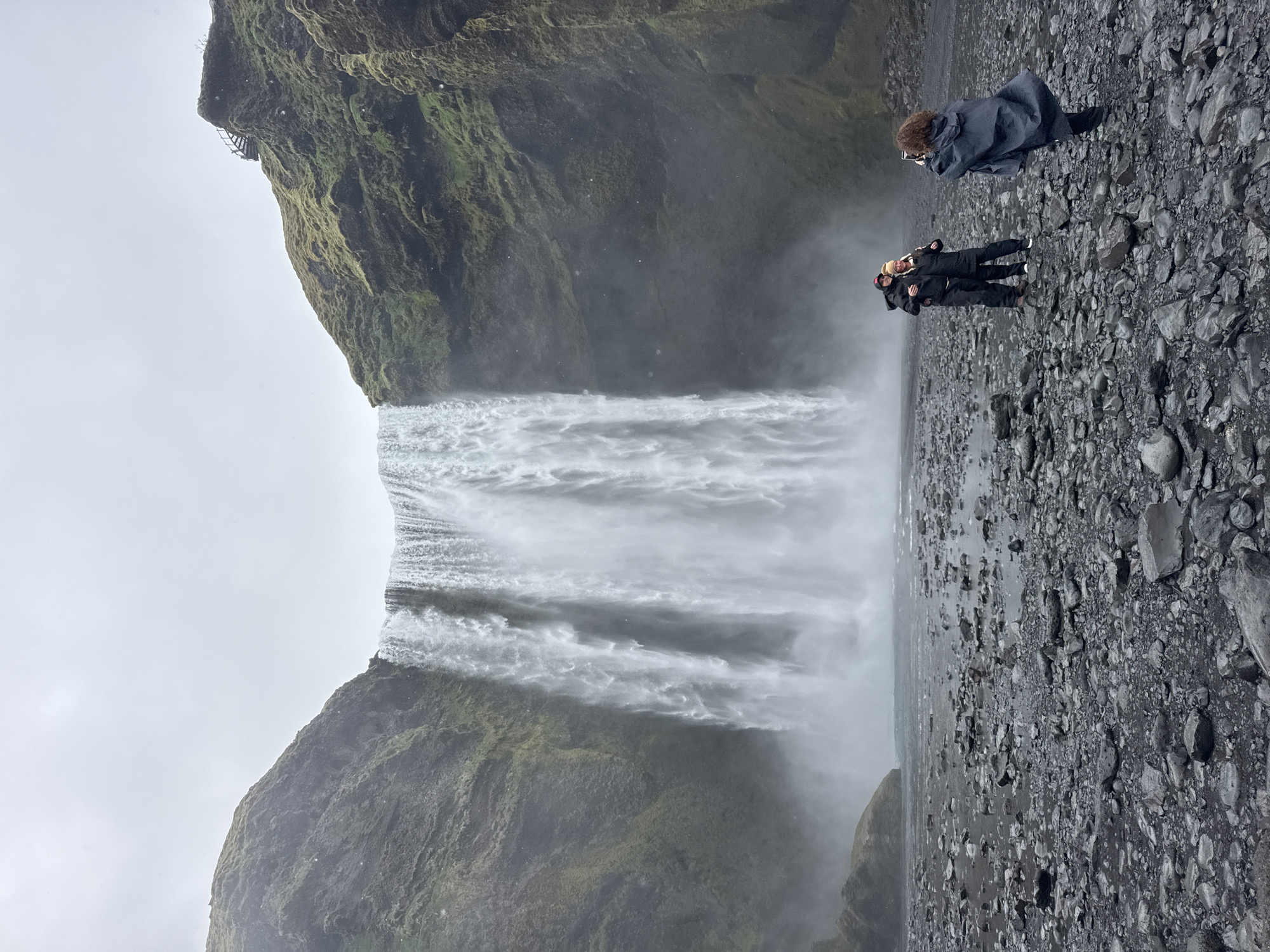 Tourist documents typical day at Iceland's Skógafoss waterfall