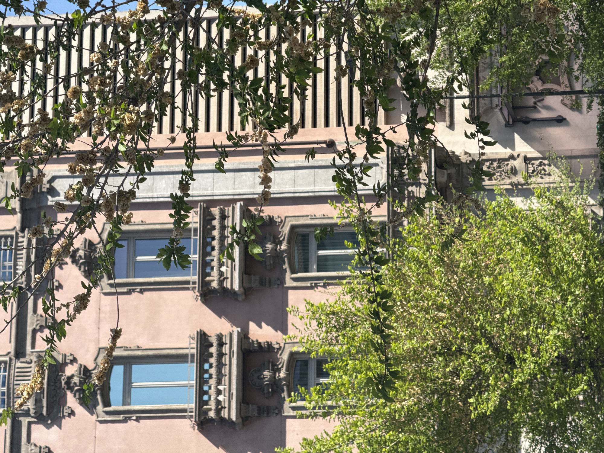 Milan morning moments: pink building facade, indoor escalator ride