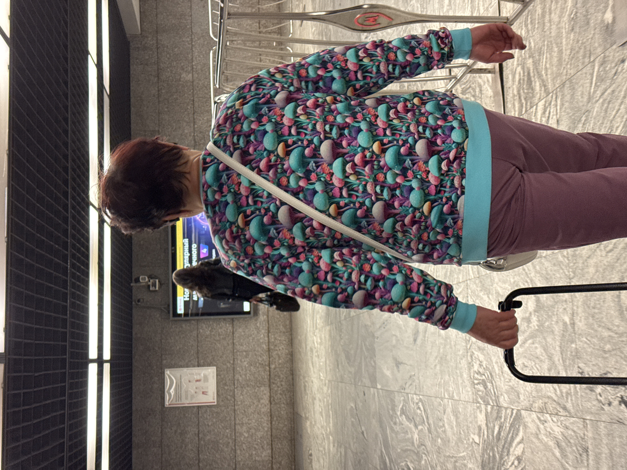 Moscow Metro station — green-lit arches, luggage, morning transit