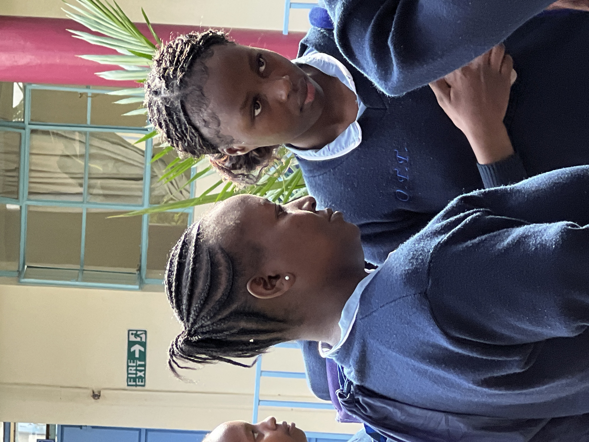 School students gather outdoors in uniforms in Nyeri