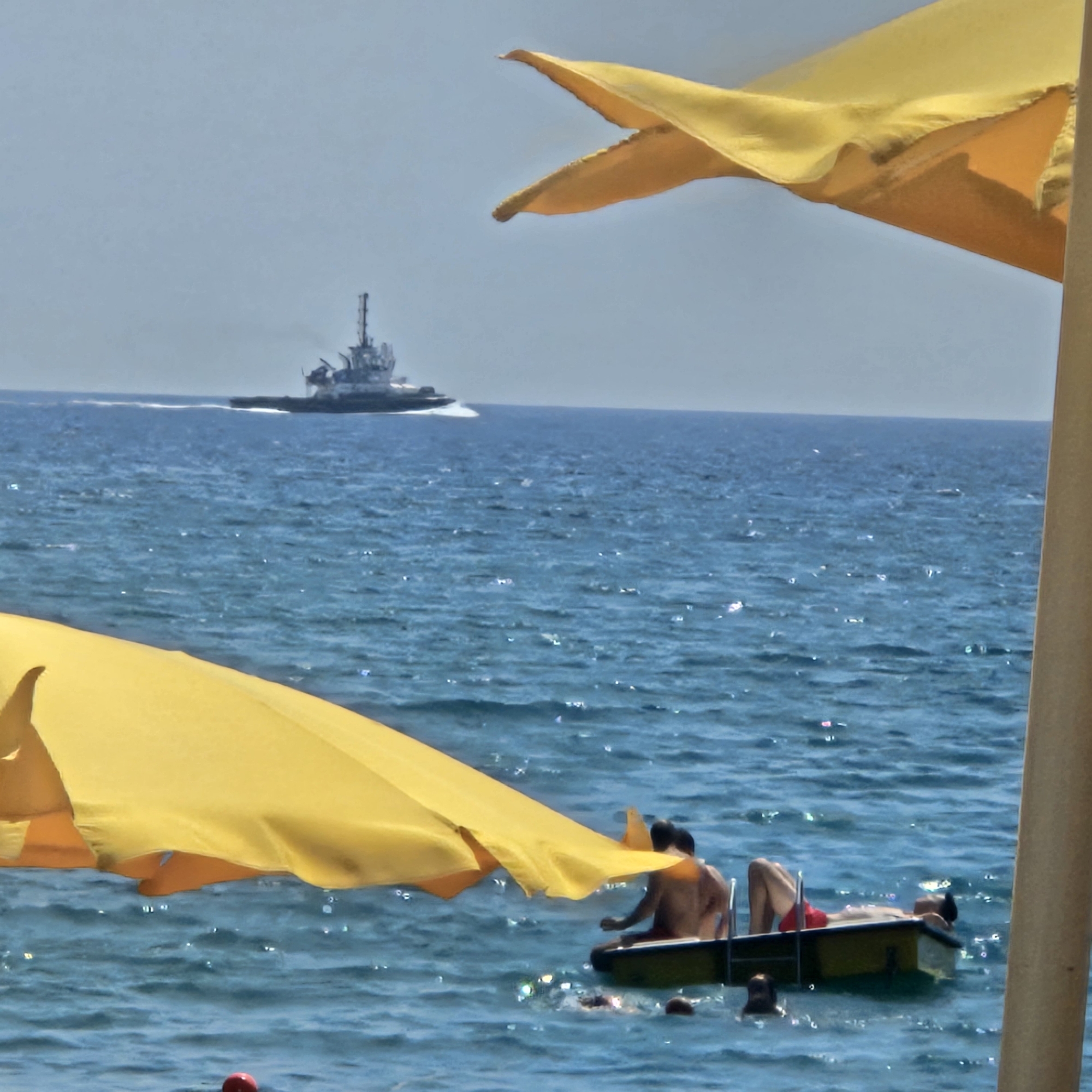 Catamaran launch, kites, and beach life in Savona