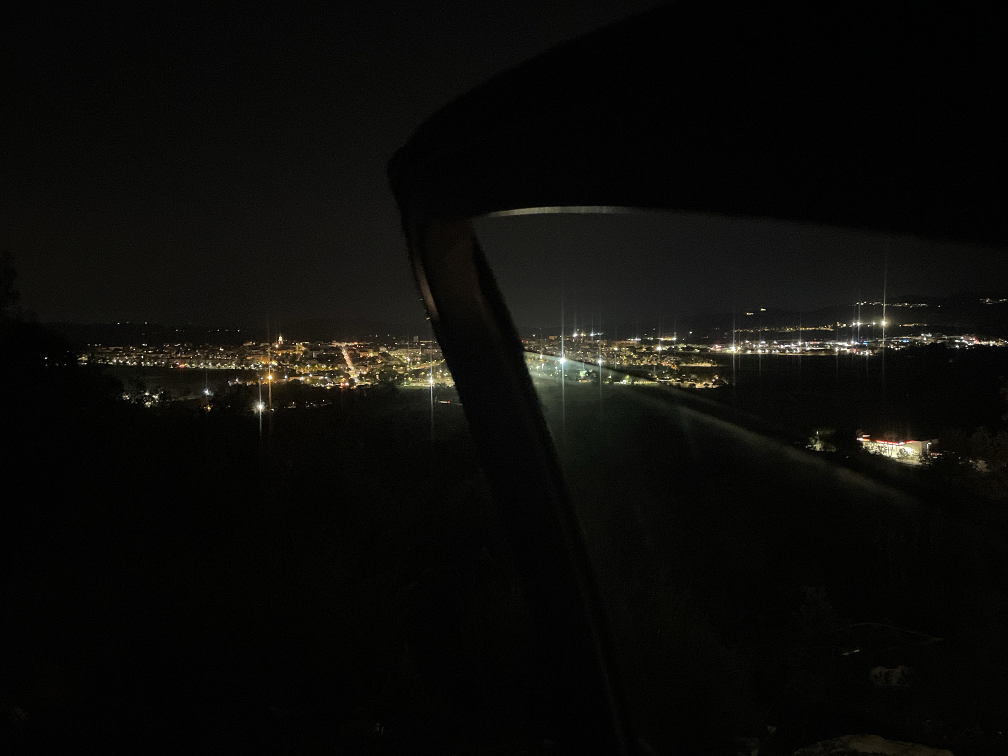 Nighttime lights illuminate Pacs del Penedès from elevated viewpoint