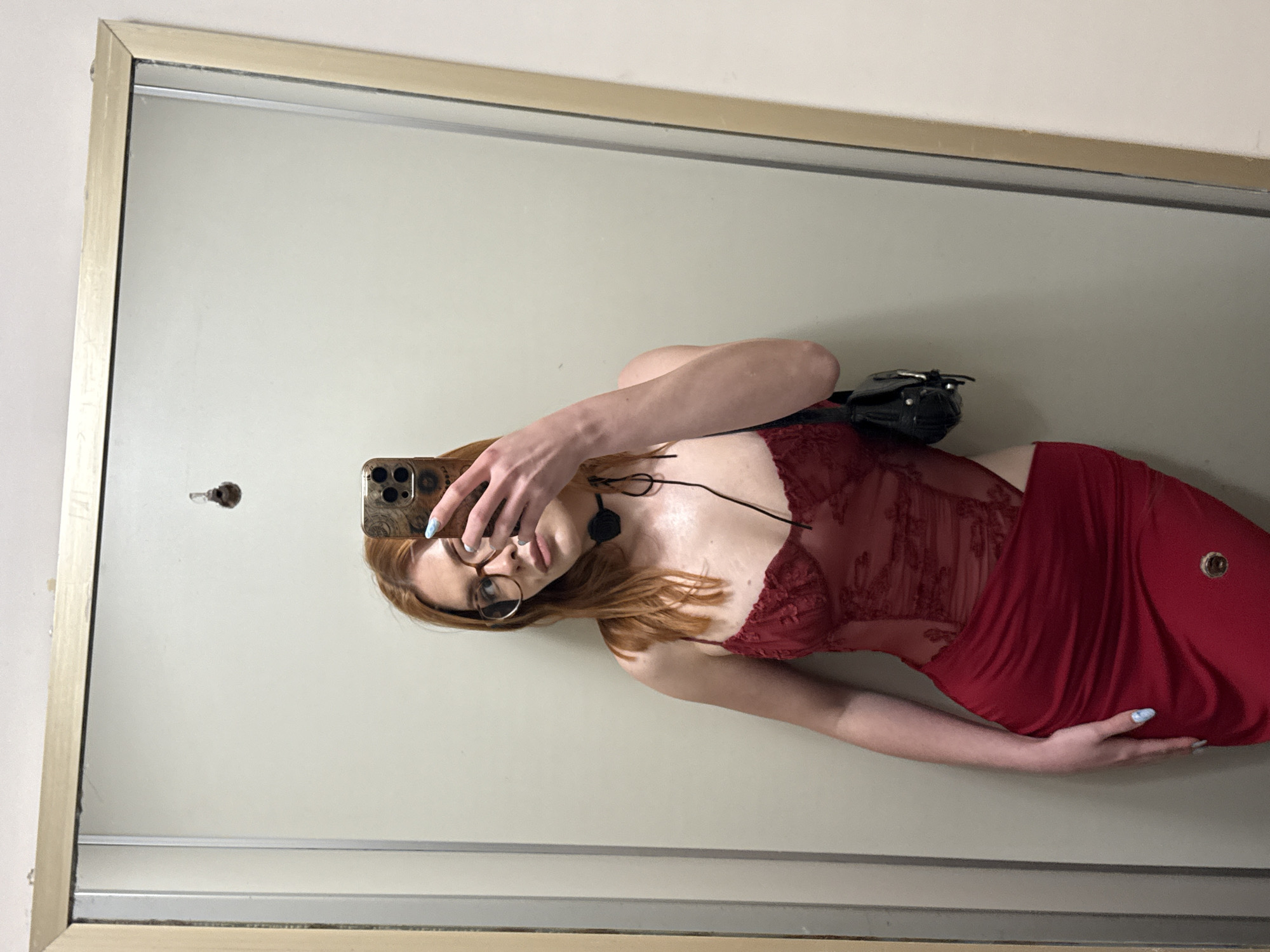 Woman takes mirror selfie in red dress, Sanremo