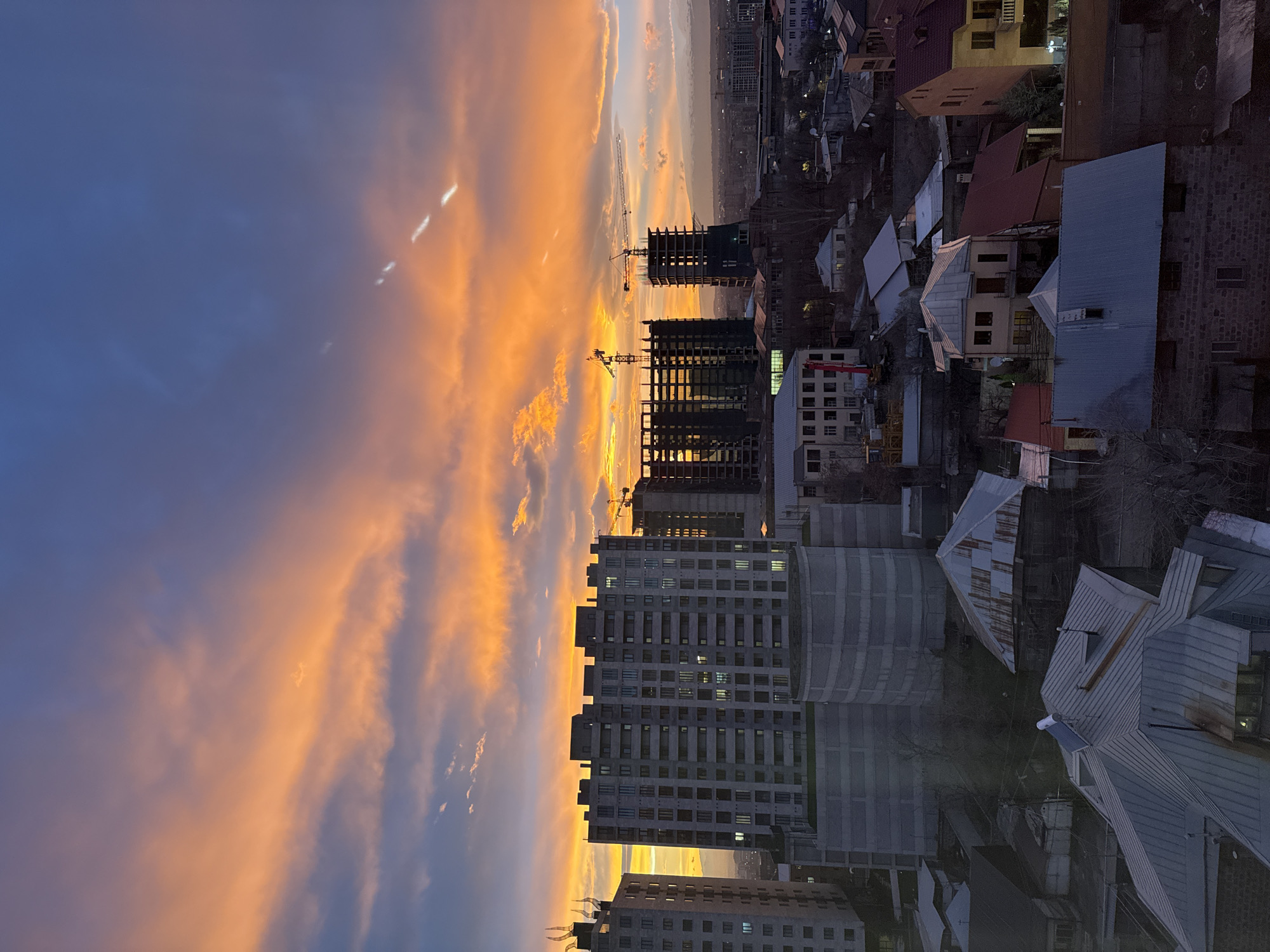 Vibrant sunset captured over Yerevan cityscape during twilight hours