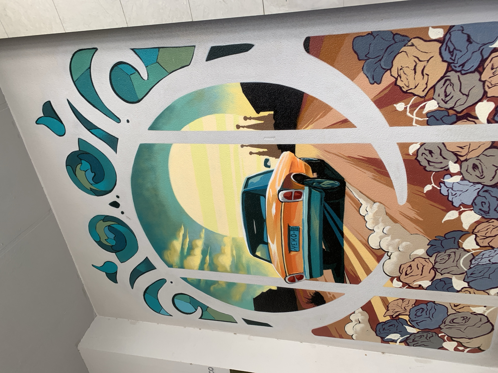 Orange car mural depicts departure from Barcelona cityscape