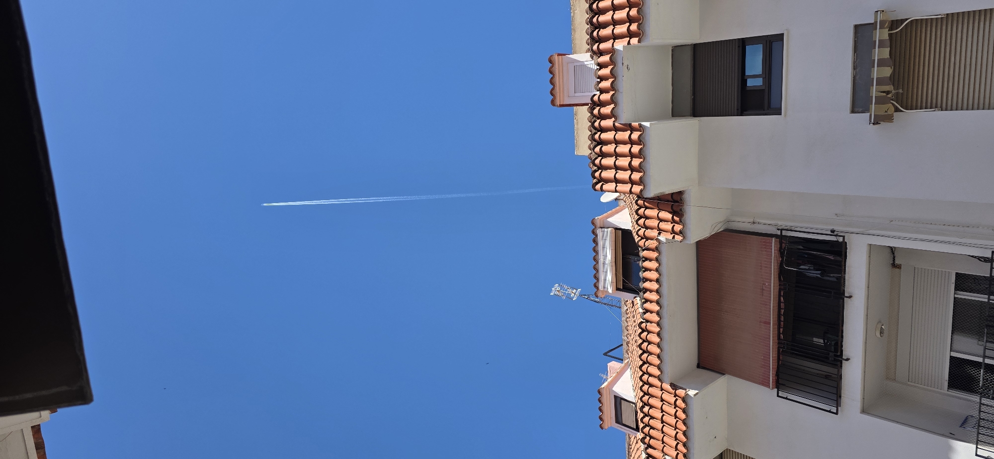 Aircraft leaves contrail over clear skies in Sagunto, Spain