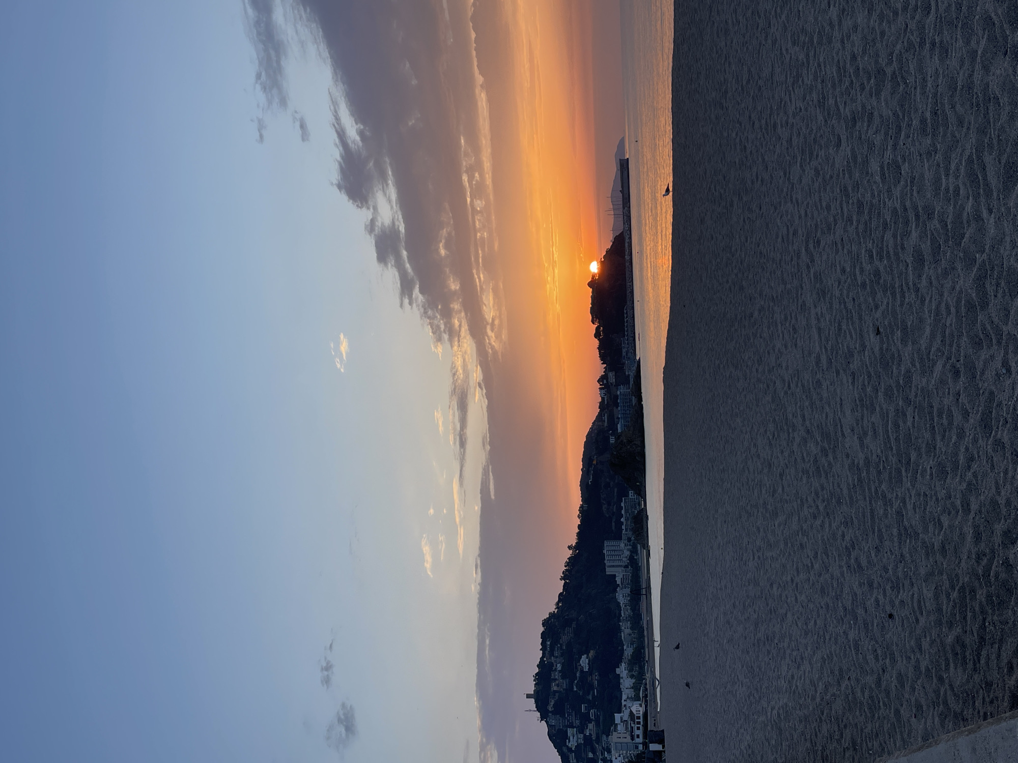 Sunset on a Blanes beach, two birds on the sand