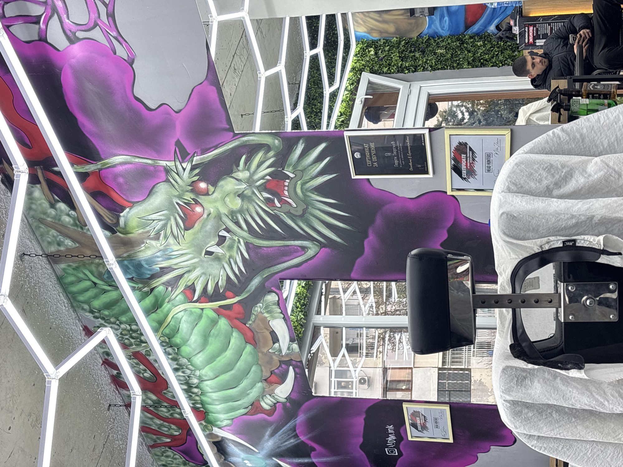 Dragon mural and wooden sculpture spotted in Varna barbershop