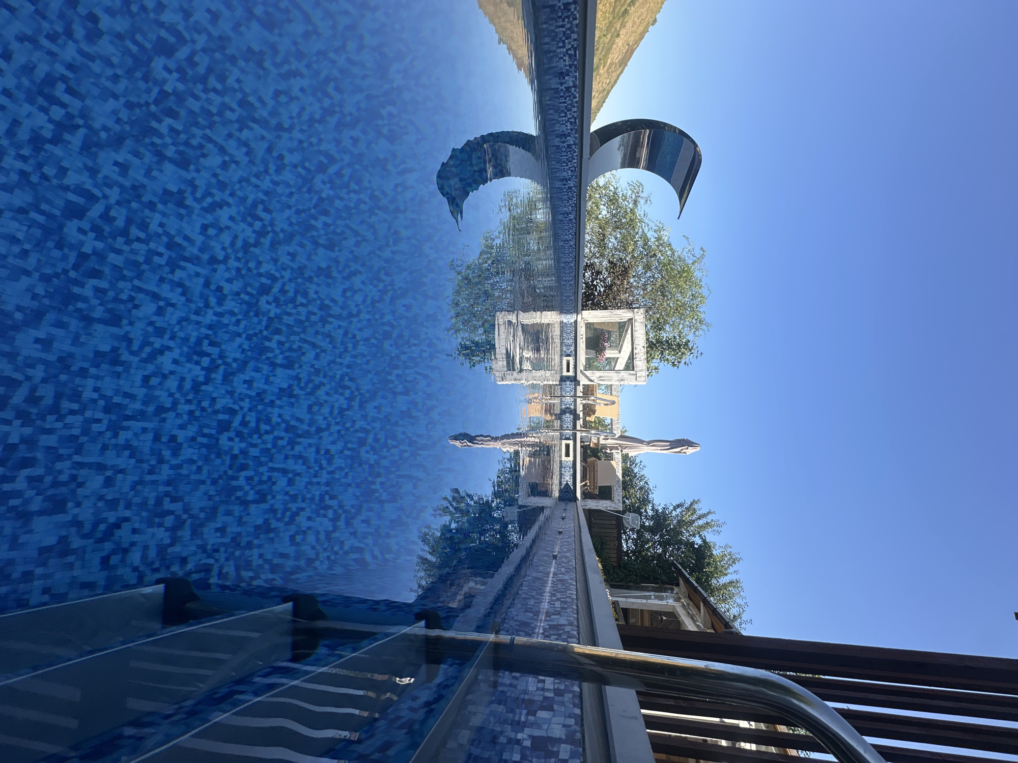 Blue mosaic pool with chrome railings, Almaty
