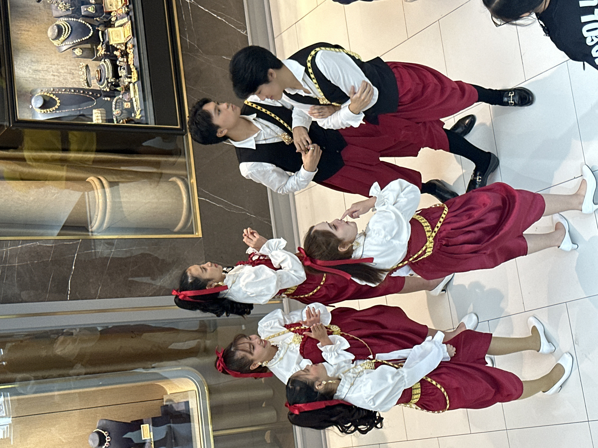 Traditional dancers perform in Bangkok shopping mall near jewelry store