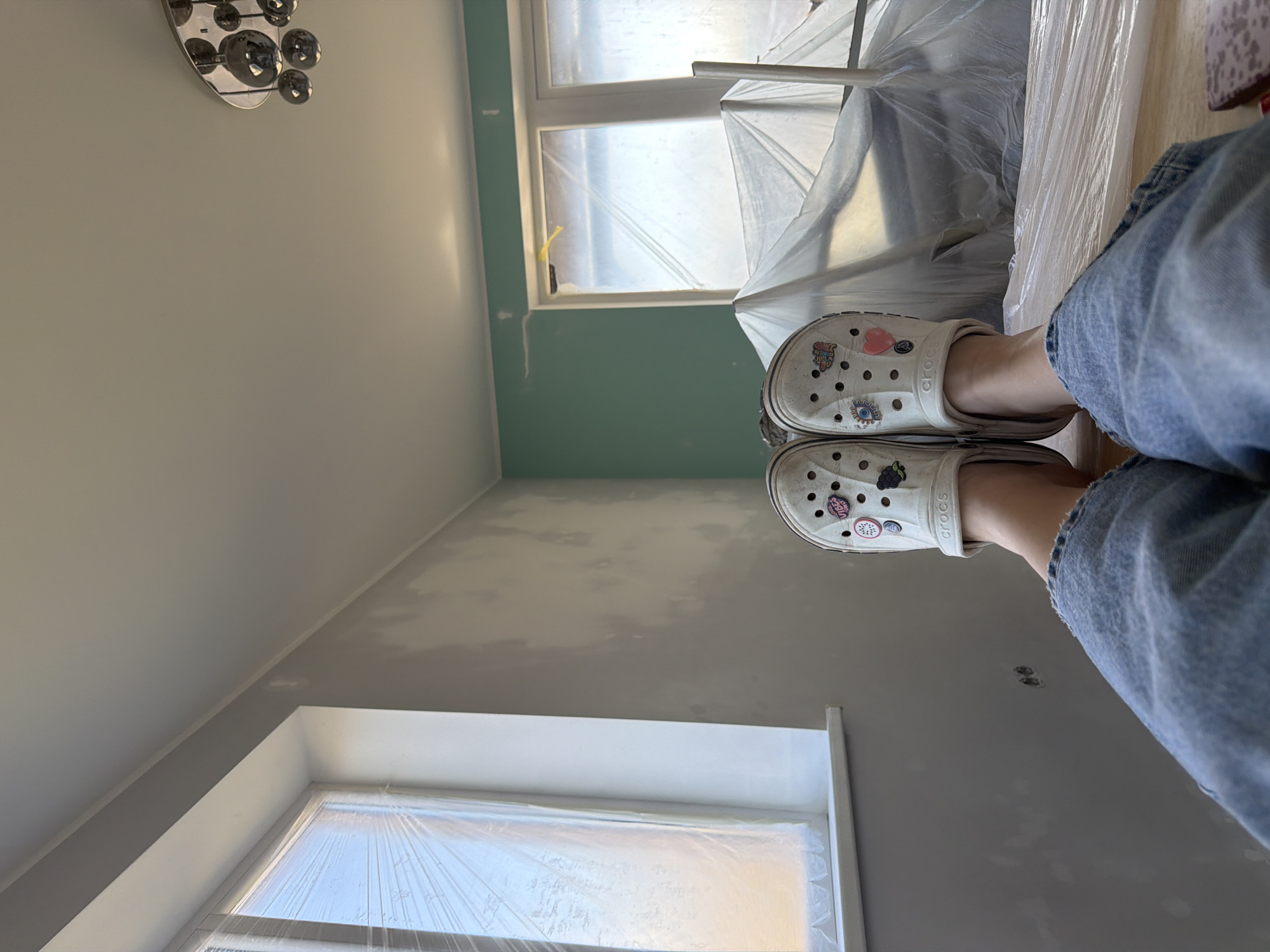 Person in Crocs stands in renovation site in Latvia