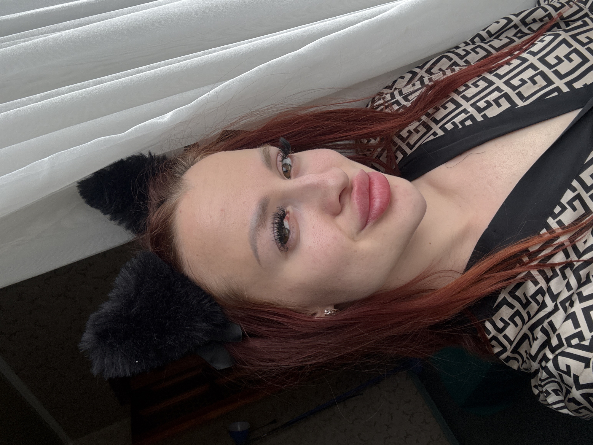 Woman in cat ears photographed in bedroom, Simferopol