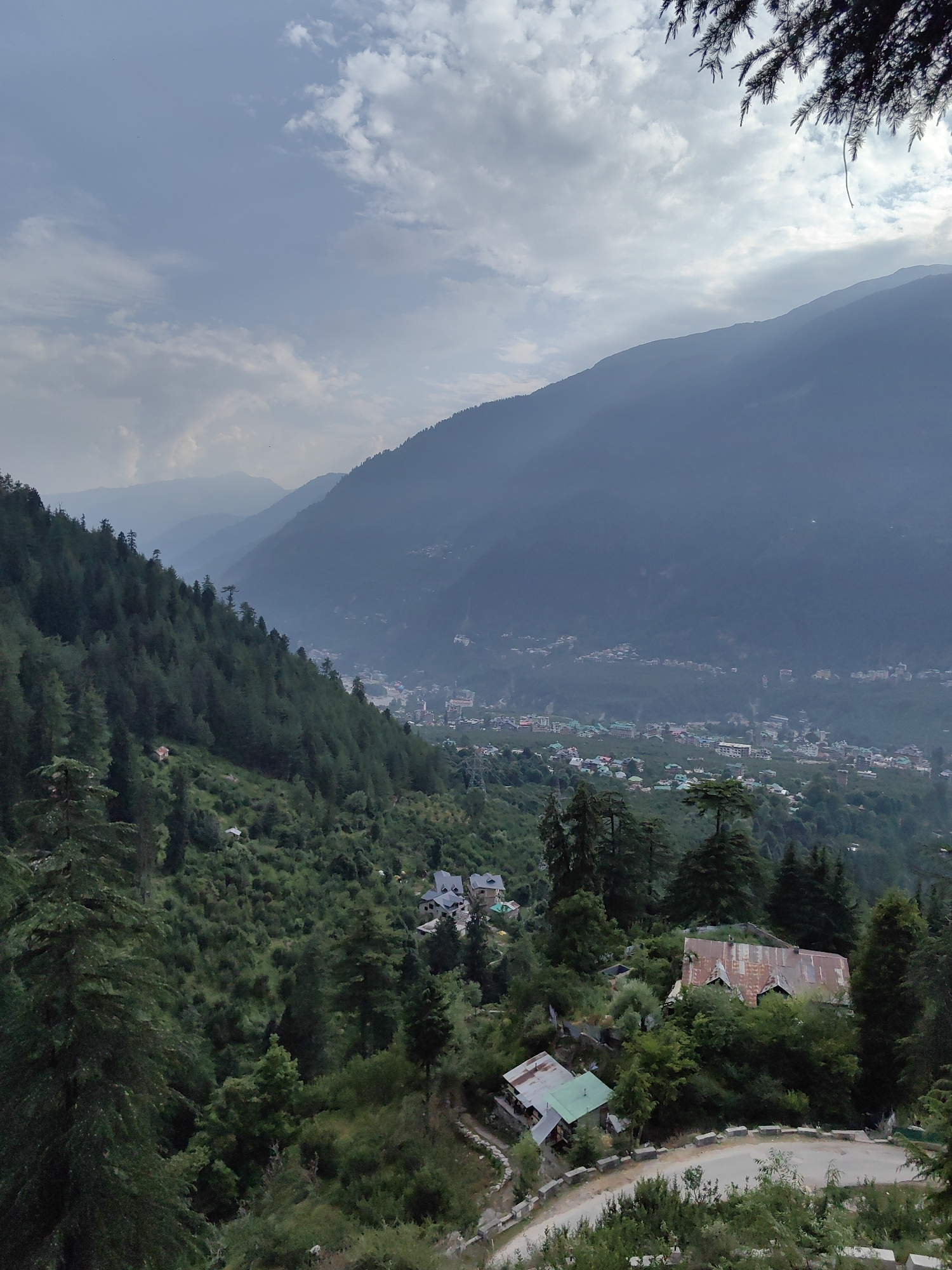 Temples, prayer flags, and mountain mist over Prini village