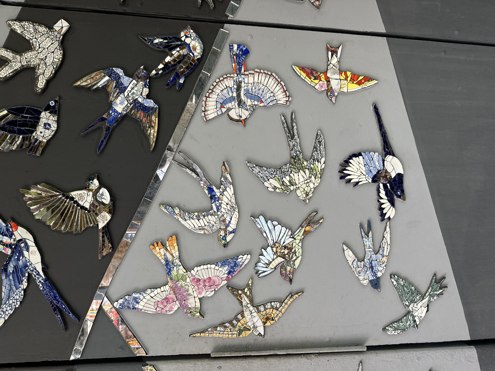 Mosaic bird wall and courtyard café scene in Saint Petersburg
