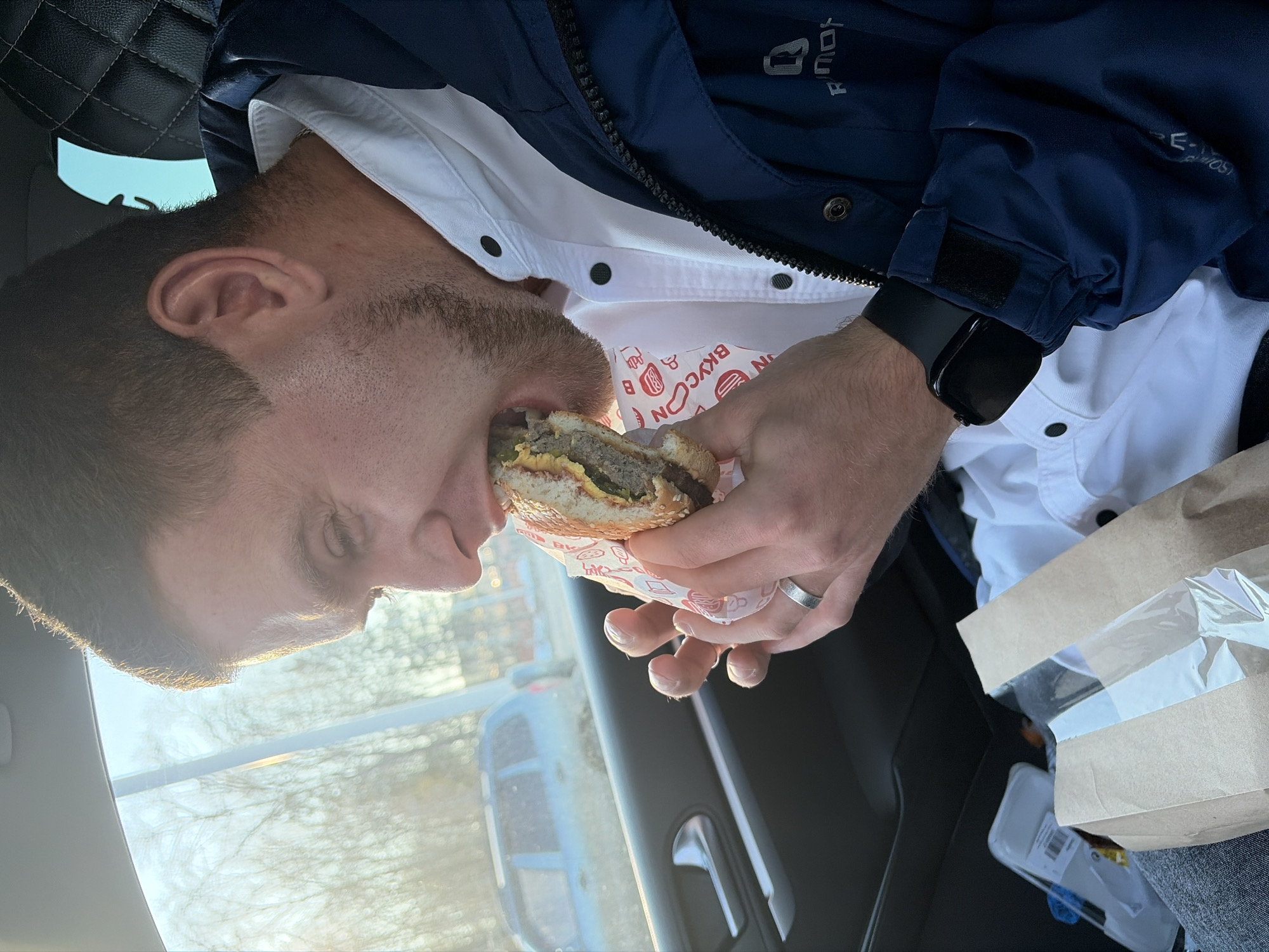 Man eats hamburger in car in Votkinsk, Russia