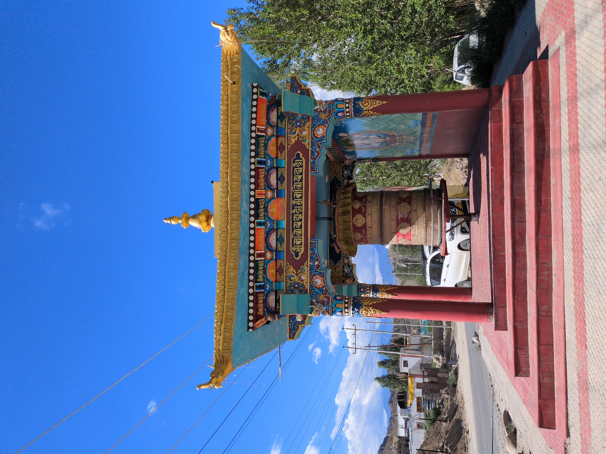 Buddhist prayer wheels and arid mountain landscape in Leh