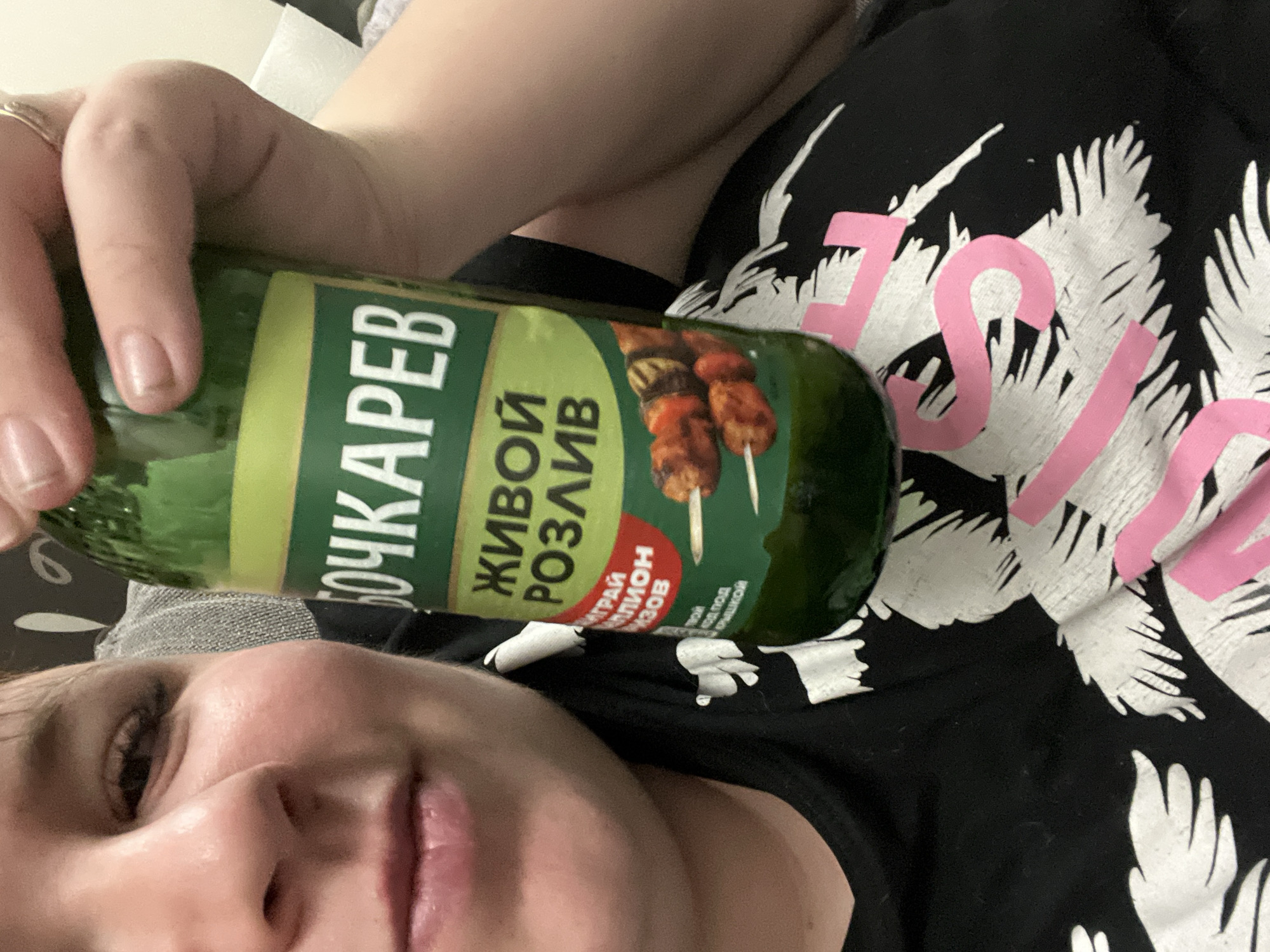 Person holds specialty Bochkarev beer bottle in Chaikovsky selfie