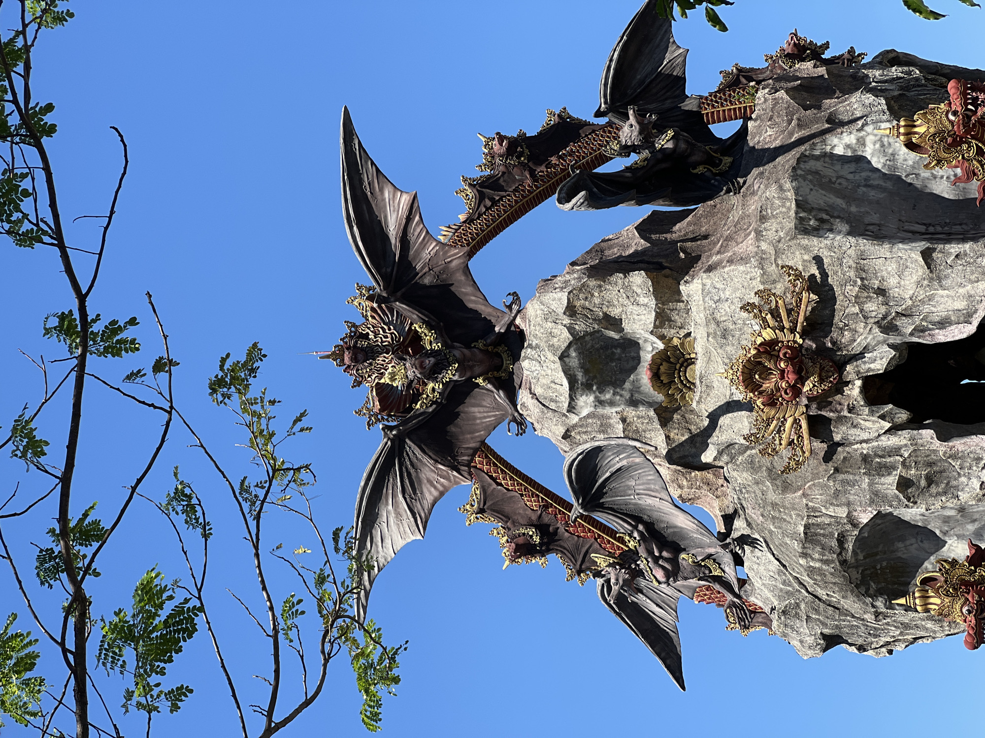 Dragon sculptures and mythical stonework at Dawan's Dewa Citra Shrine