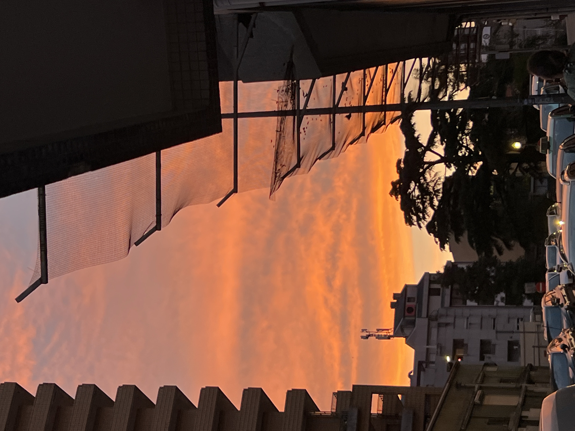 Vibrant sunset with crescent moon observed across Porto, Portugal